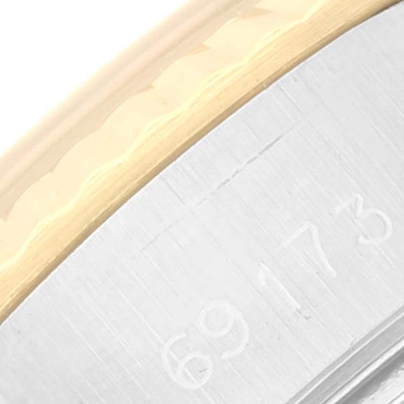 The image shows a close-up of the Rolex Datejust 69173 Women's Steel and Gold (two tone) Champagne Dial 69173 Women's Steel and Gold (two tone) Champagne Dial model's bracelet, highlighting a part of the reference number and the two-tone metal.