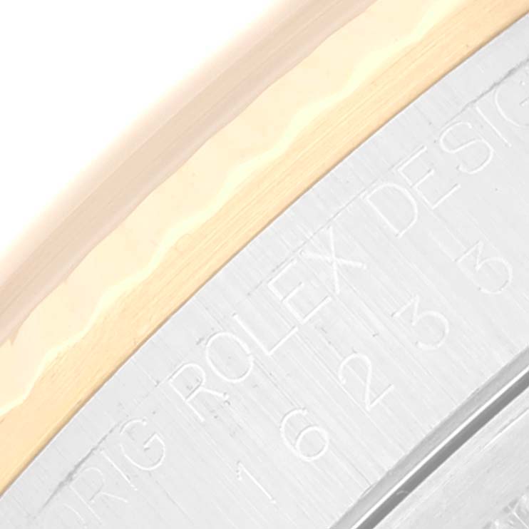 This close-up image shows the side engraving and part of the bezel of a Rolex Datejust 16233 Men's Steel and Gold (two tone) Champagne Dial 16233 Men's Steel and Gold (two tone) Champagne Dial watch.