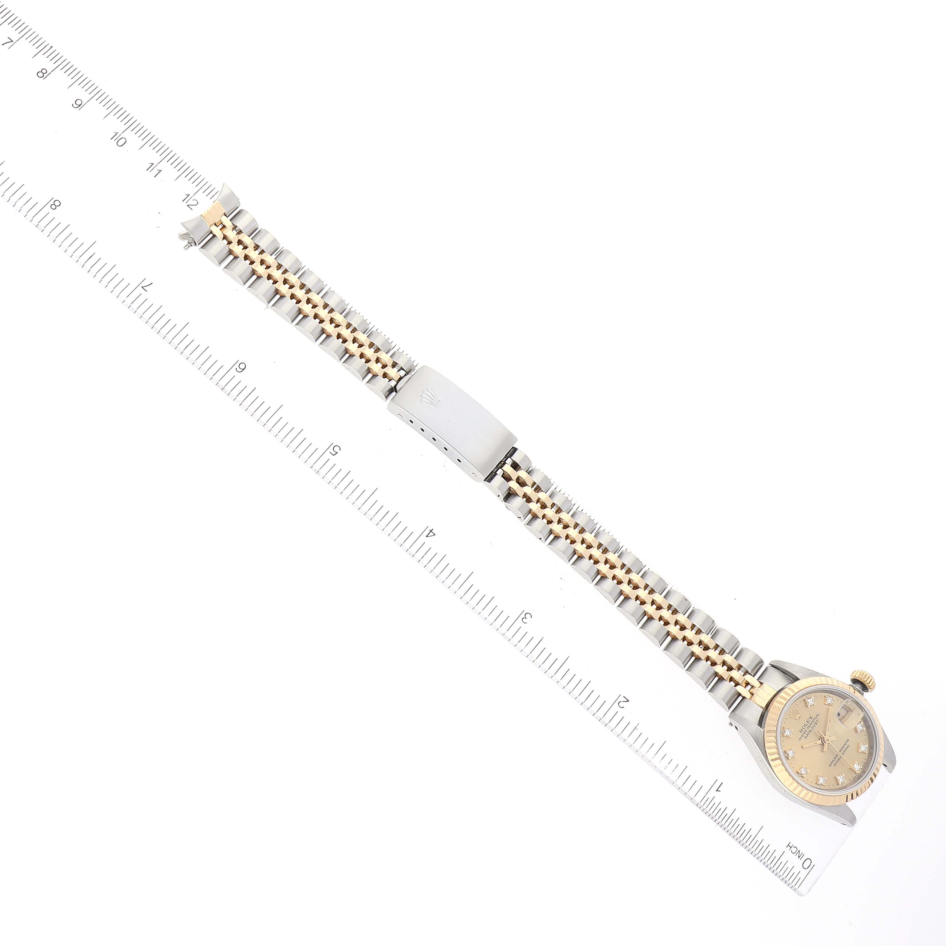 The image shows a Rolex Datejust 69173 Women's Steel and Gold (two tone) Champagne Dial 69173 Women's Steel and Gold (two tone) Champagne Dial watch laid flat with a ruler demonstrating its length.