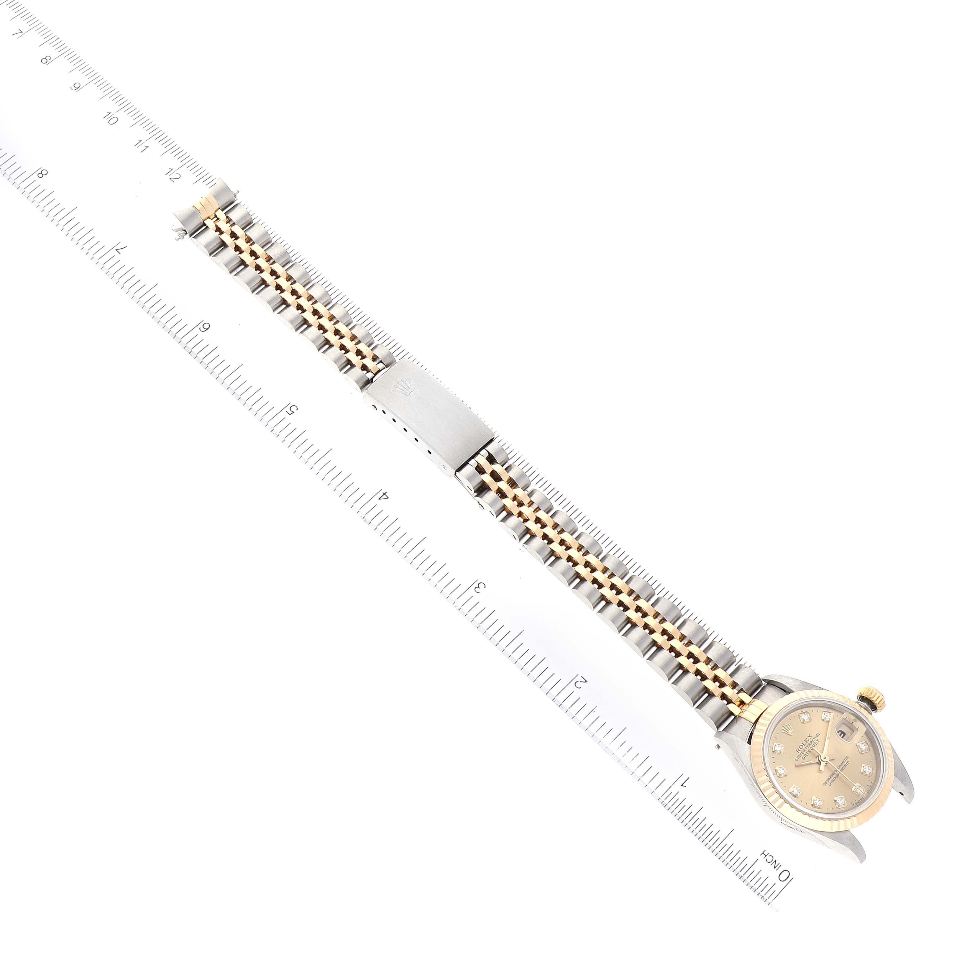 The image shows a Rolex Datejust 69173 Women's Steel and Gold (two tone) Champagne Dial 69173 Women's Steel and Gold (two tone) Champagne Dial watch laid flat with its entire face and band visible, alongside a ruler.