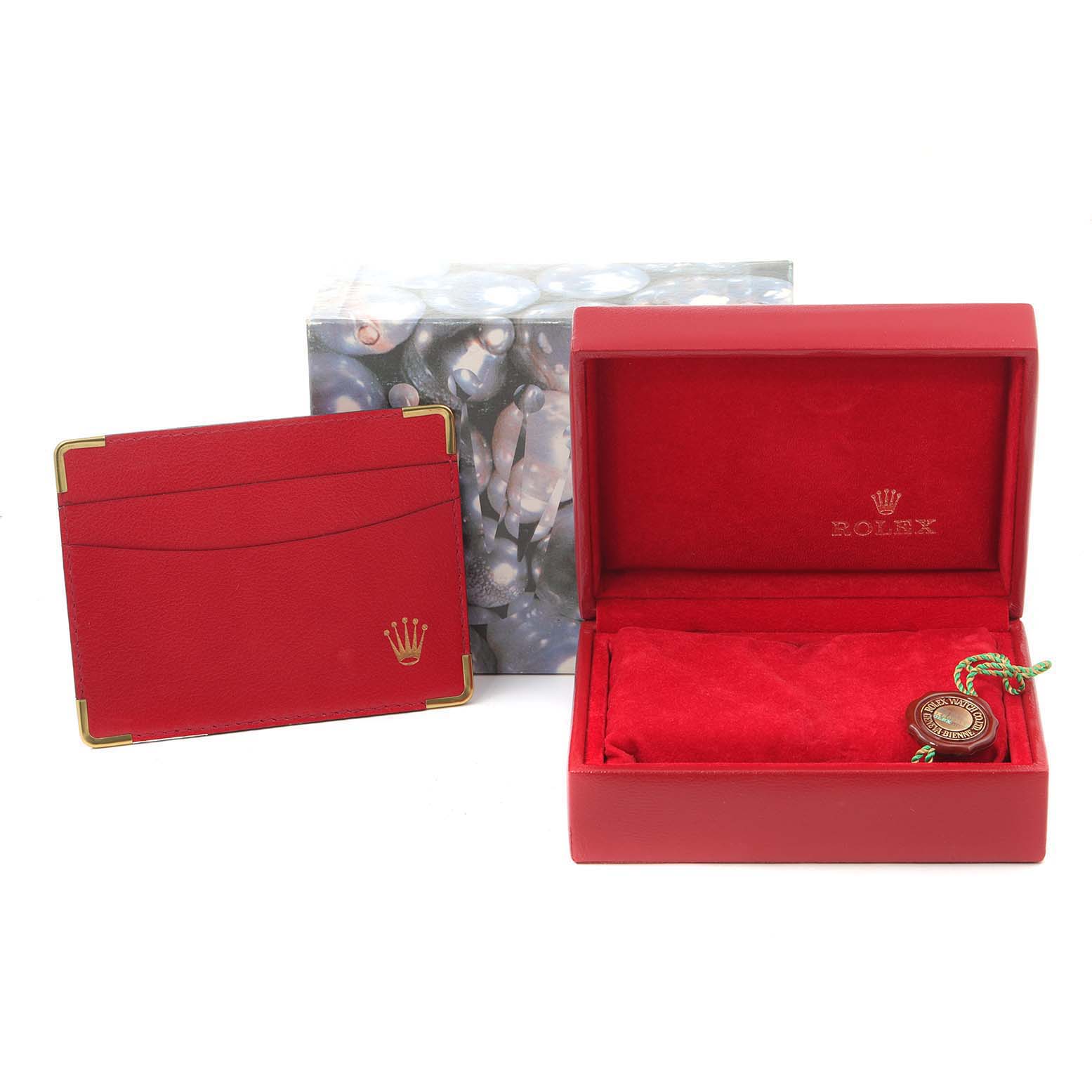 The image shows a Rolex Datejust 79173 Women
s Steel and Gold (two tone) Mother of Pearl Dial 79173 Women
s Steel and Gold (two tone) Mother of Pearl Dial watch
s red box, cardholder, and tag, along with an outer decorative box.