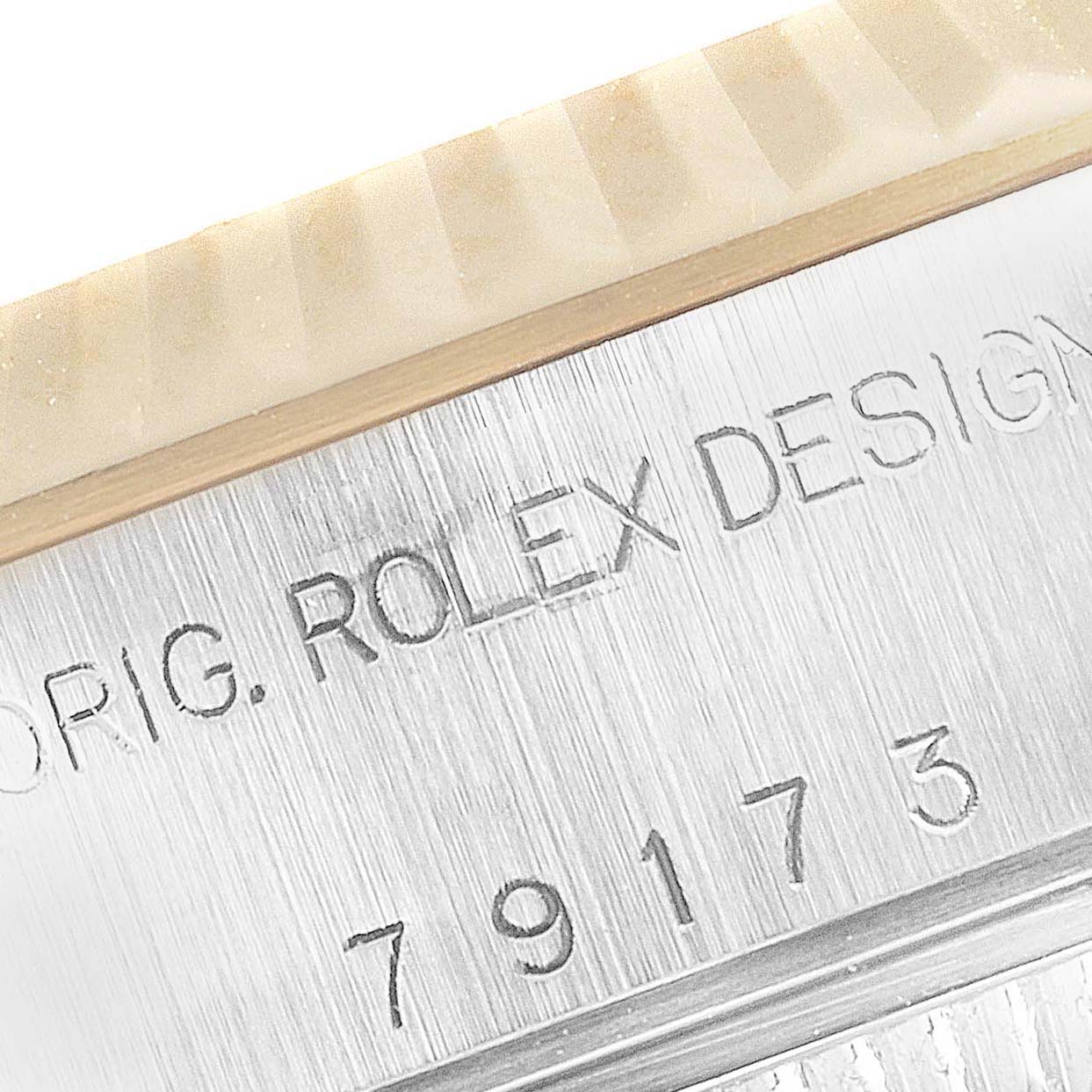 This image shows a close-up of the inscription and serial number on the side of the Rolex Datejust 79173 Women
s Steel and Gold (two tone) Mother of Pearl Dial 79173 Women
s Steel and Gold (two tone) Mother of Pearl Dial watch case.