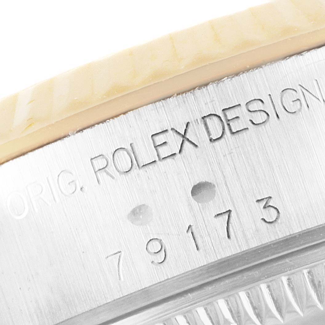 The image shows a close-up of the side of a Rolex Datejust 79173 Women's Steel and Gold (two tone) Mother of Pearl Dial 79173 Women's Steel and Gold (two tone) Mother of Pearl Dial watch, highlighting the engraved model number and design details.