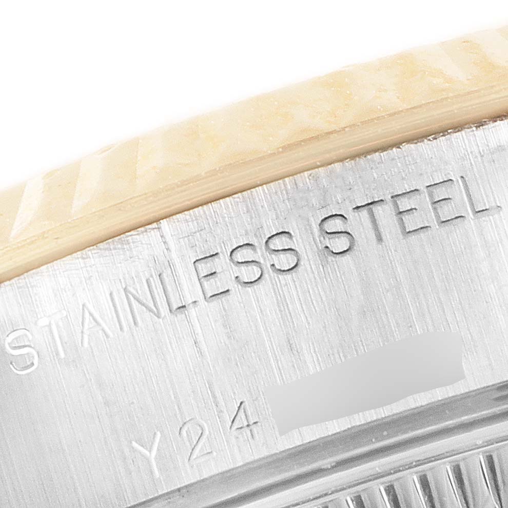 This close-up image shows the stainless steel inscription and serial number on the Rolex Datejust 79173 Women
s Steel and Gold (two tone) Grey Dial 79173 Women
s Steel and Gold (two tone) Grey Dial watch case.