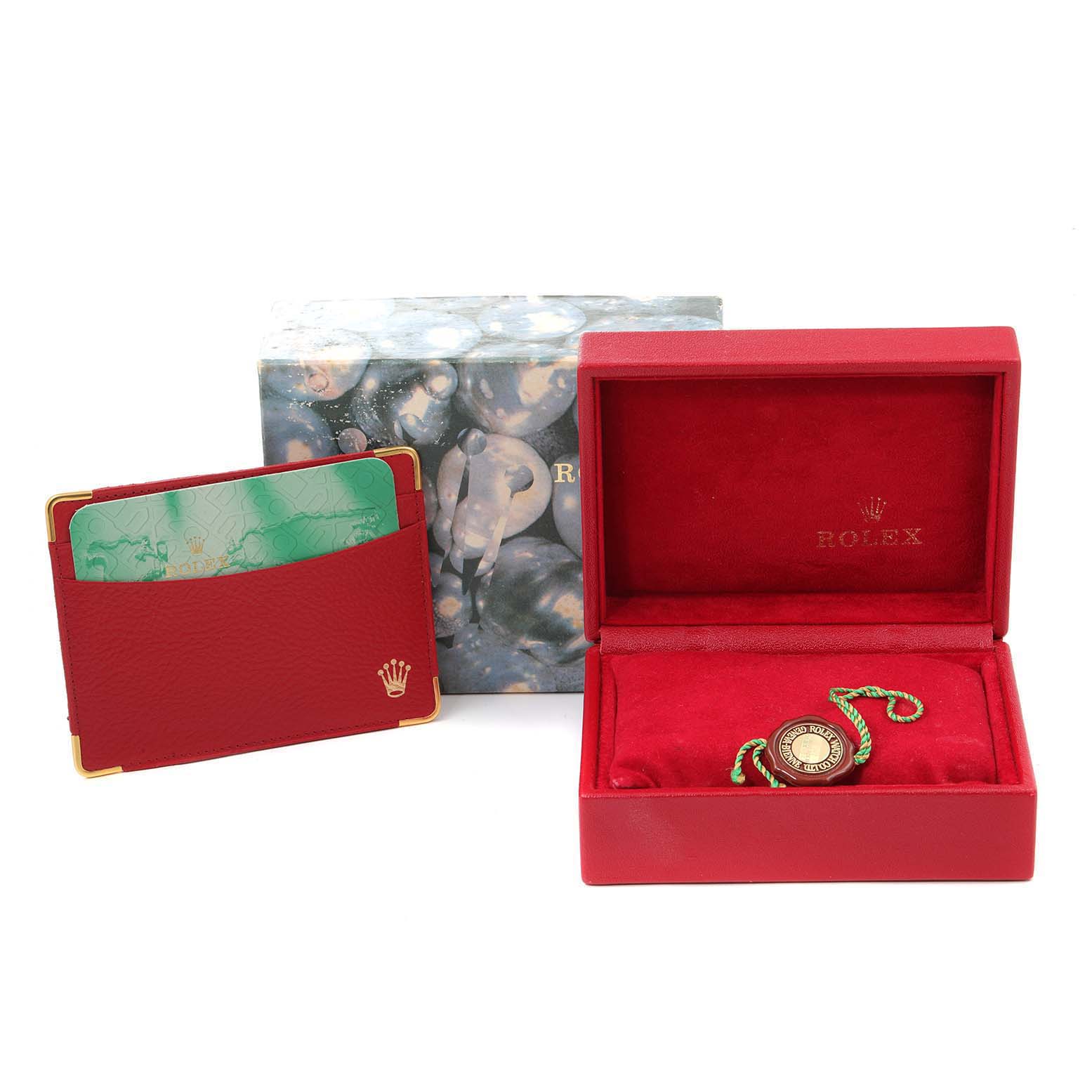The image shows accessories for a Rolex Datejust 79173 Women
s Steel and Gold (two tone) Grey Dial 79173 Women
s Steel and Gold (two tone) Grey Dial model, including a red watch box and a cardholder.
