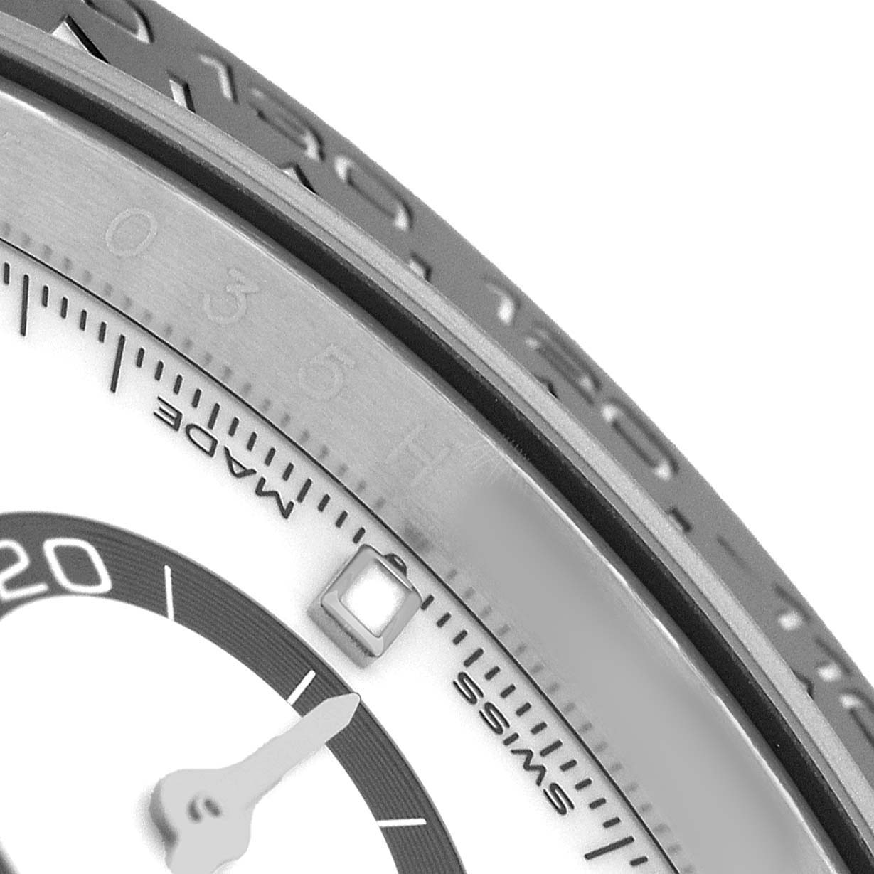 The image shows a close-up angle of a Rolex Daytona 126500 Men's Stainless Steel White Dial watch, highlighting the dial, part of the bezel, and an hour marker.