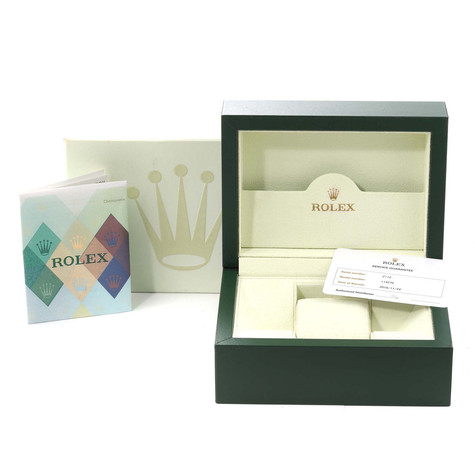 The image shows an open box for a Rolex Explorer 114270 Men
s Stainless Steel Black Dial 114270 Men
s Stainless Steel Black Dial watch, along with a booklet and a warranty card.