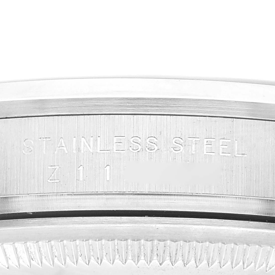 This image shows a close-up of the side profile of the case back on a Rolex Explorer 114270 Men
s Stainless Steel Black Dial 114270 Men
s Stainless Steel Black Dial watch, highlighting the "STAINLESS STEEL" engraving.