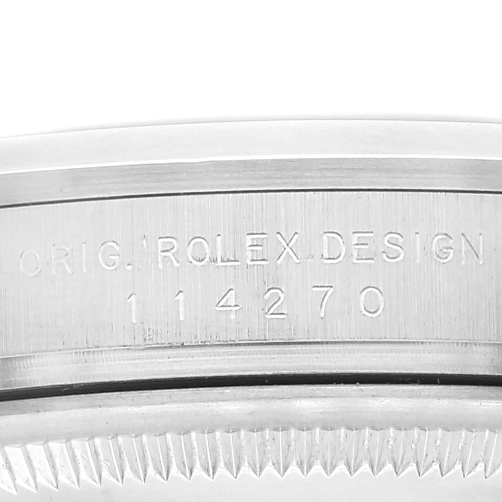 This close-up image shows the engraved model number "114270" on the casing of a Rolex Explorer 114270 Men
s Stainless Steel Black Dial 114270 Men
s Stainless Steel Black Dial watch.