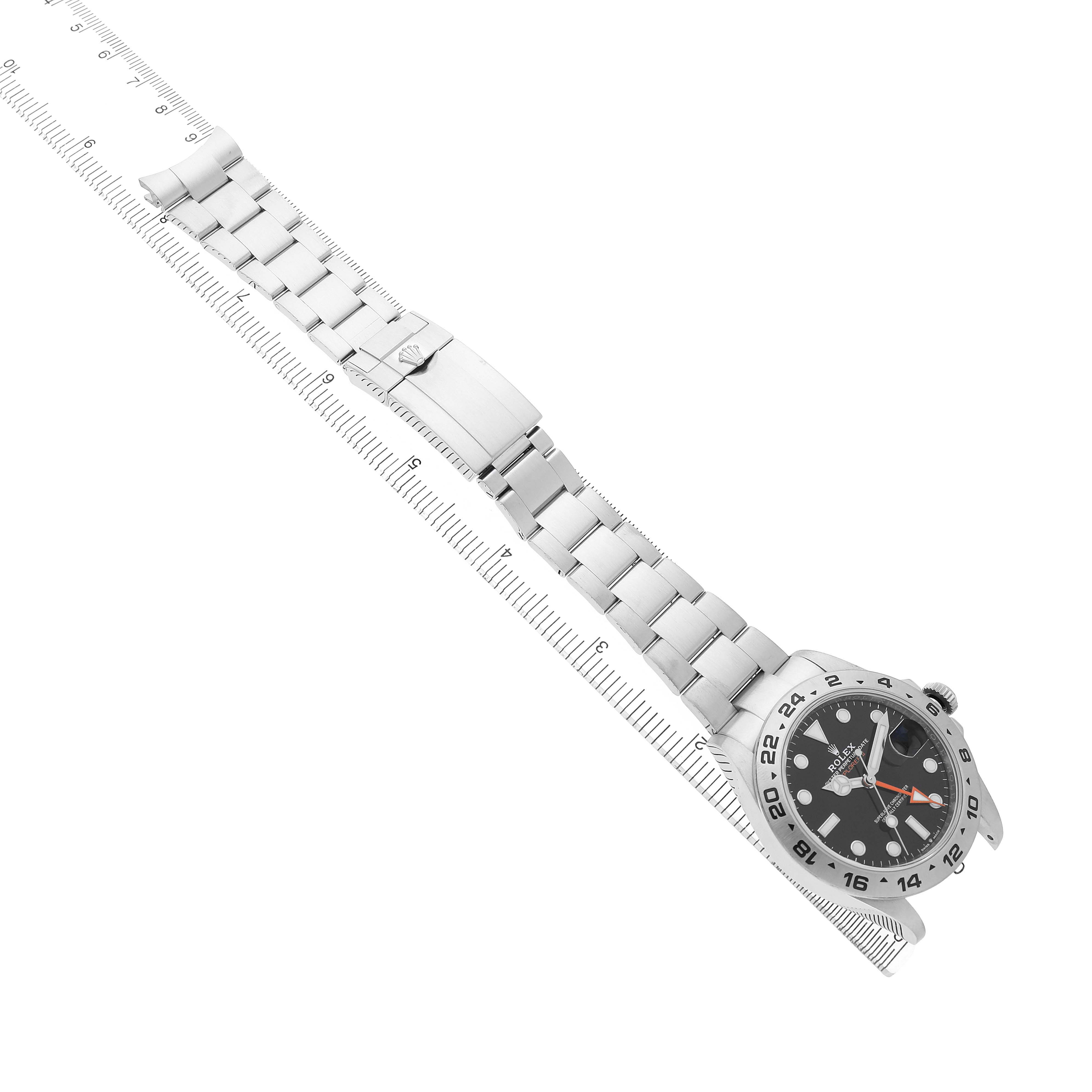 The Rolex Explorer 226570 Men's Stainless Steel Black Dial watch is shown from an angled top view, displaying the dial and full bracelet with a ruler underneath.