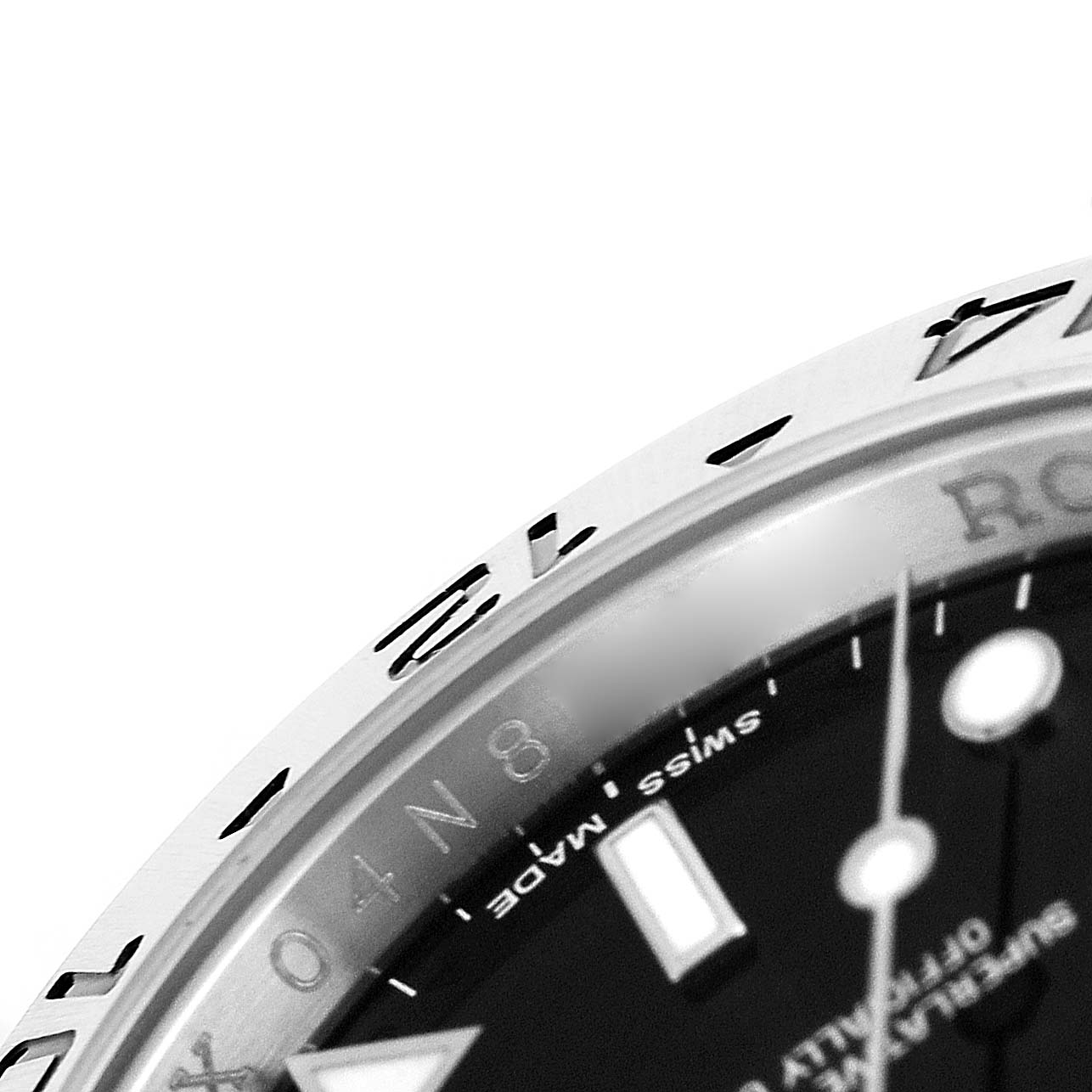 The image shows a close-up of the bezel and part of the dial of a Rolex Explorer 16570 T Men's Stainless Steel Black Dial watch, highlighting its numerals and markers.