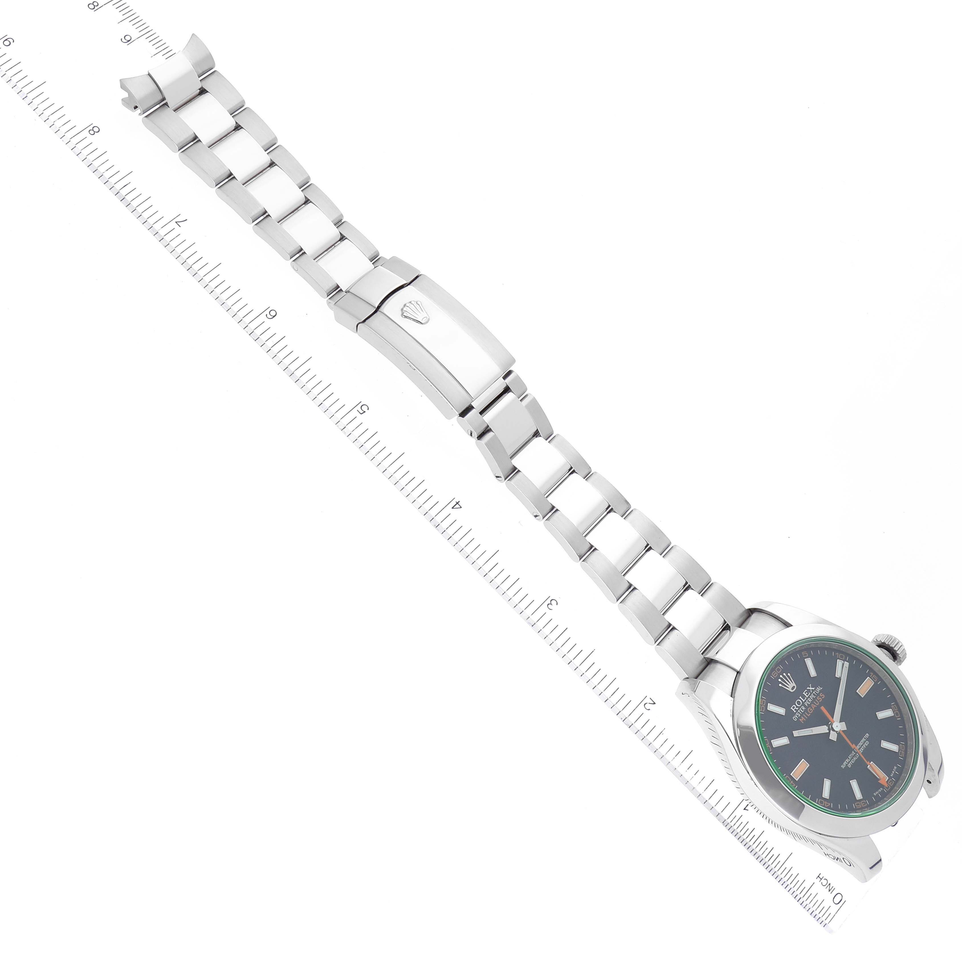 The image shows a Rolex Milgauss 116400 Men's Stainless Steel Black Dial 116400 Men's Stainless Steel Black Dial watch laid flat with its bracelet fully extended and a ruler beside it for scale.