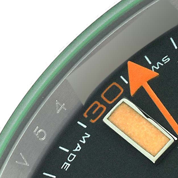 This image shows a close-up of the dial of a Rolex Milgauss 116400 Men's Stainless Steel Black Dial 116400 Men's Stainless Steel Black Dial watch, highlighting the orange second hand and minute markers.