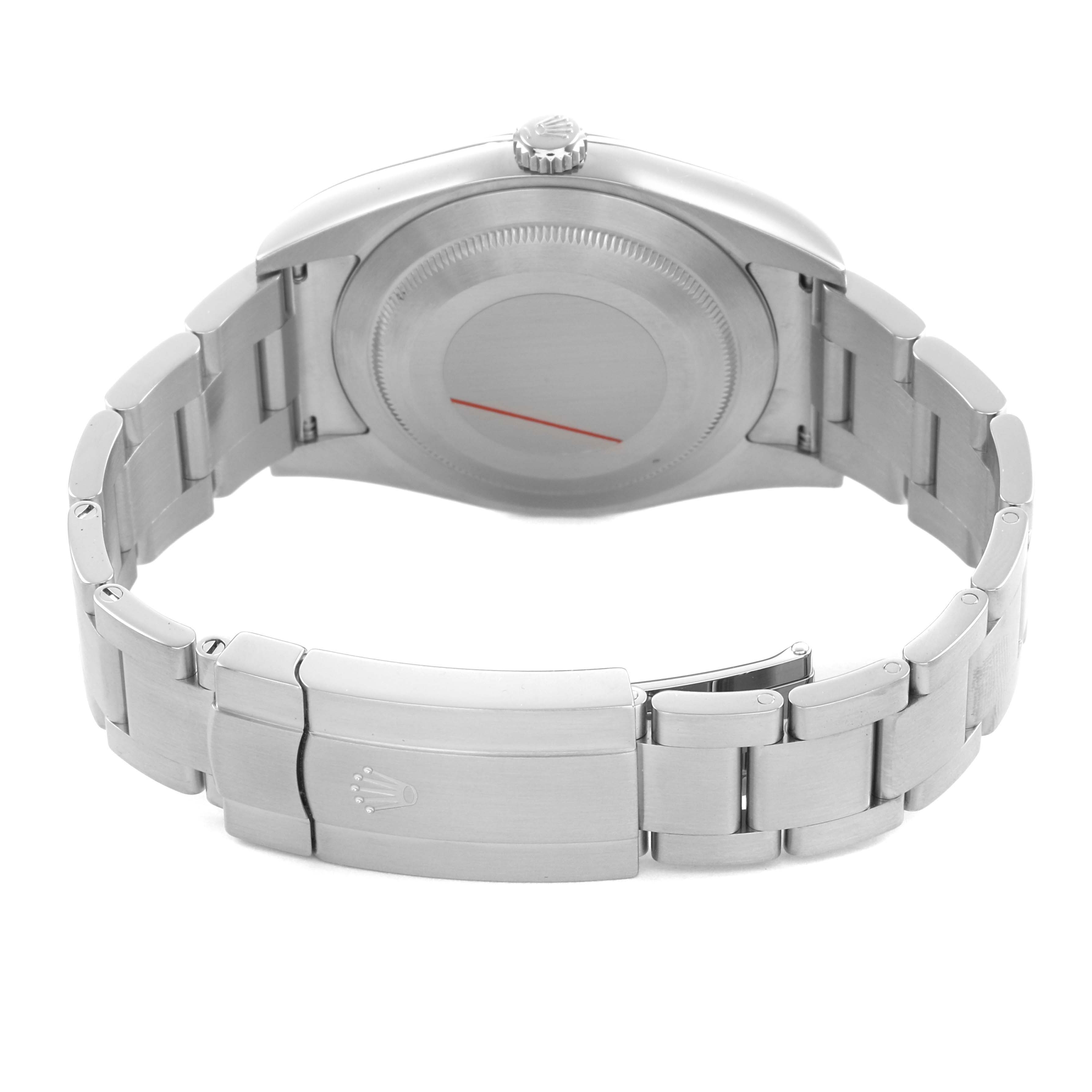 The image shows the back of a Rolex Oyster Perpetual 114300 Men's Stainless Steel Blue Dial watch and its bracelet, focusing on the clasp and caseback.