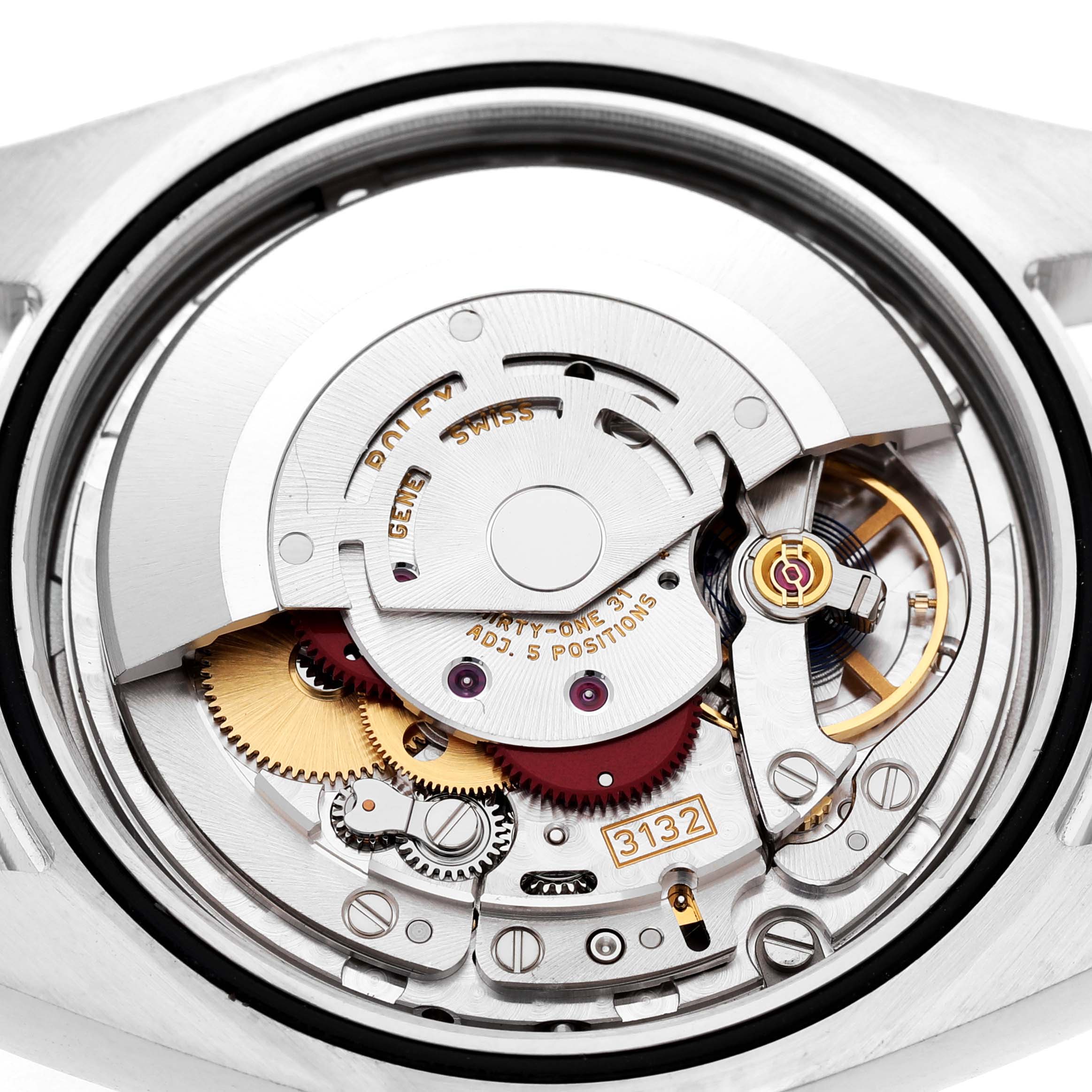 The image shows the intricate movement and mechanism of a Rolex Oyster Perpetual 114300 Men's Stainless Steel Blue Dial watch from a back angle.
