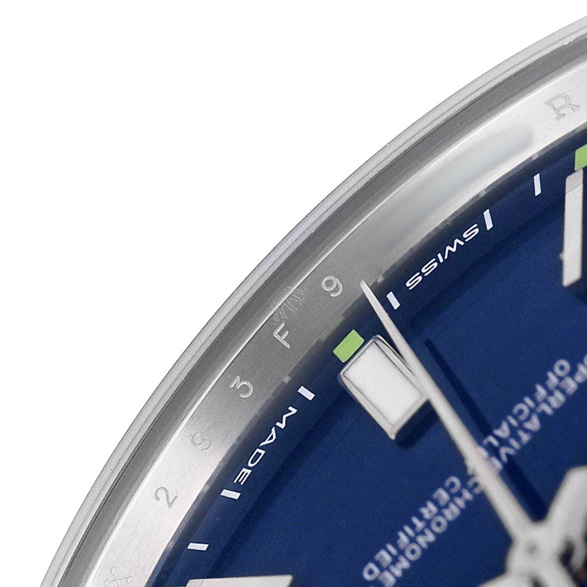 The image shows a close-up of the dial and bezel of the Rolex Oyster Perpetual 114300 Men's Stainless Steel Blue Dial, highlighting the blue face and hour markers.