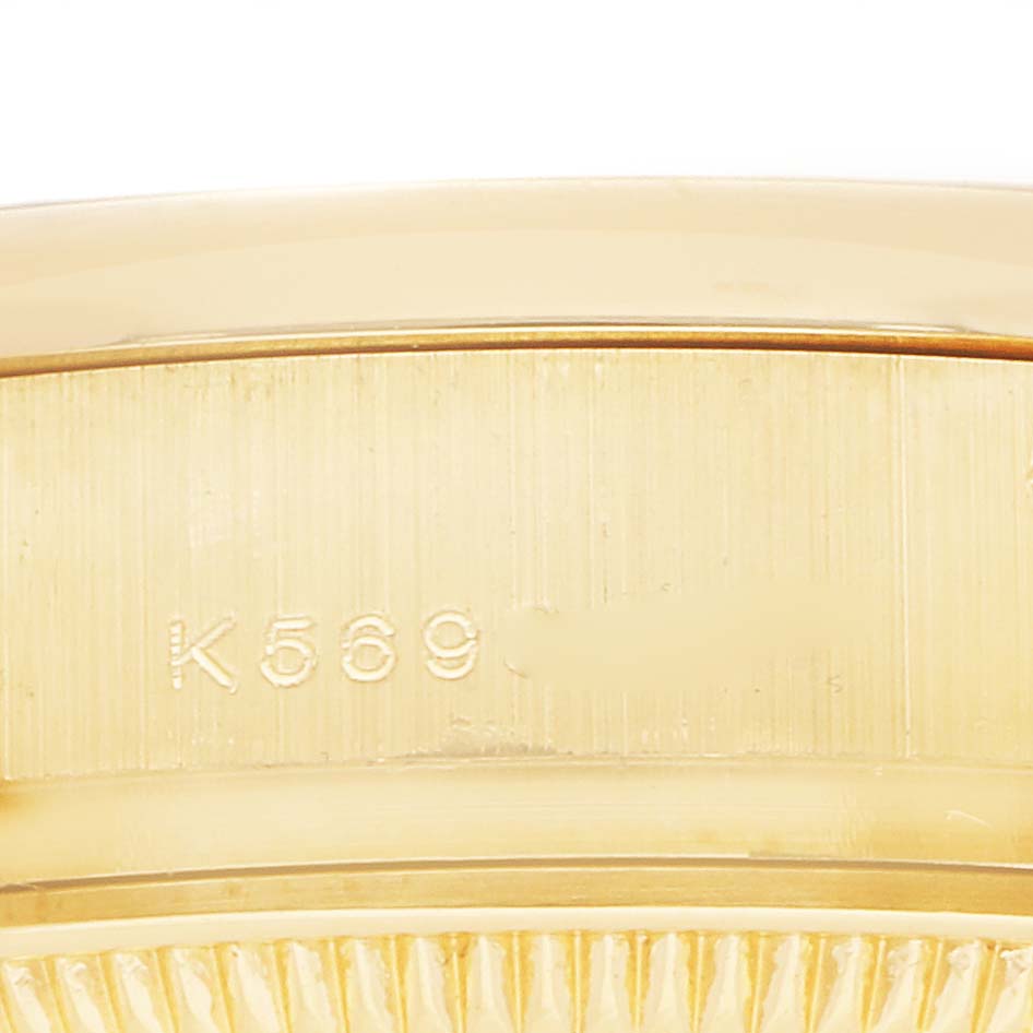 The image shows a close-up angle of the side casing of a Rolex President 179298 Women
s Yellow Gold Mother of Pearl Dial 179298 Women
s Yellow Gold Mother of Pearl Dial watch, focusing on engraved details.