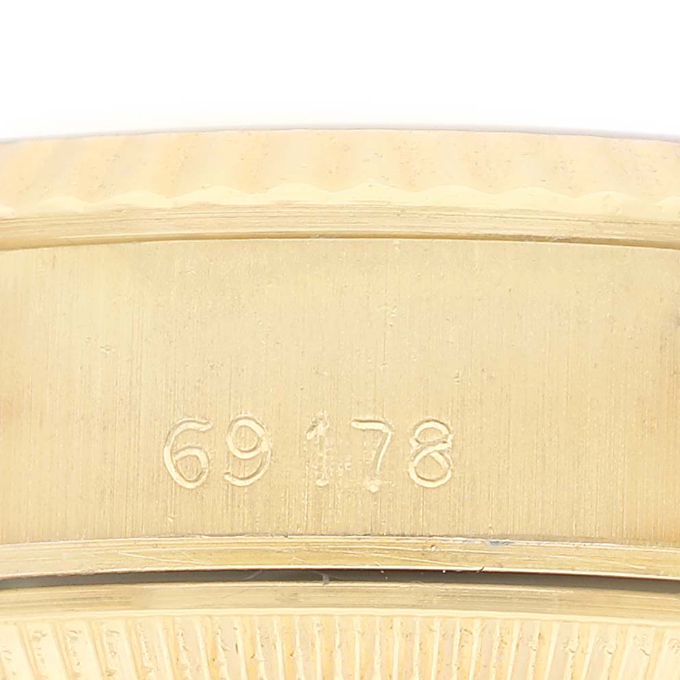 The image shows the Rolex President 69178 Women's Yellow Gold Silver Dial model's side and part of the band with its engraved serial number.
