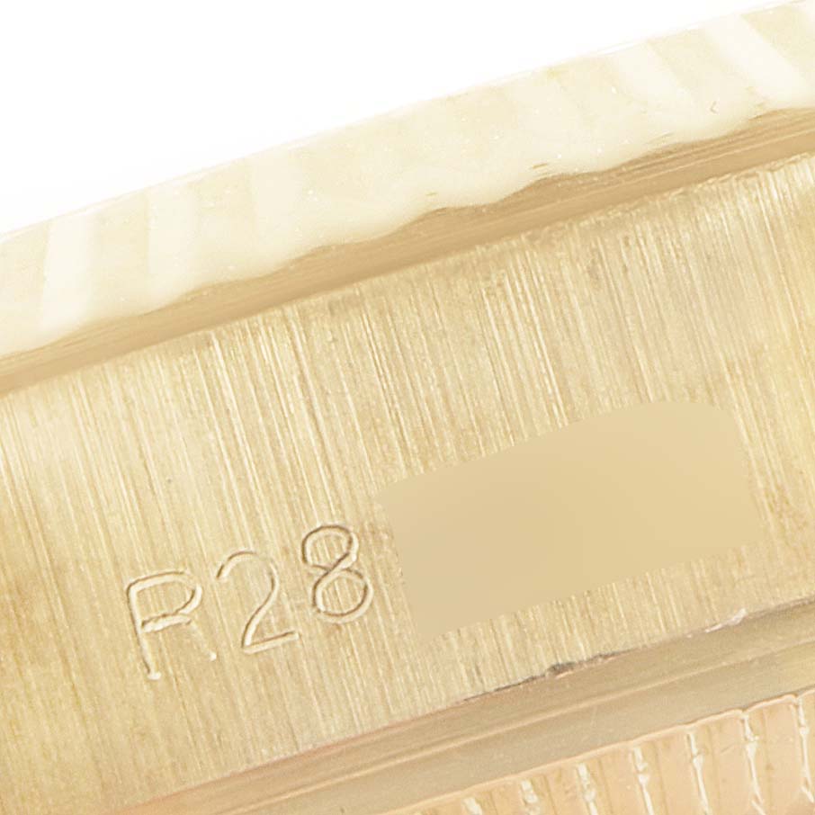 This image shows a close-up of the side of a Rolex President 69178 Women
s Yellow Gold White Dial 69178 Women
s Yellow Gold White Dial model watch, focusing on the serial number engraving.