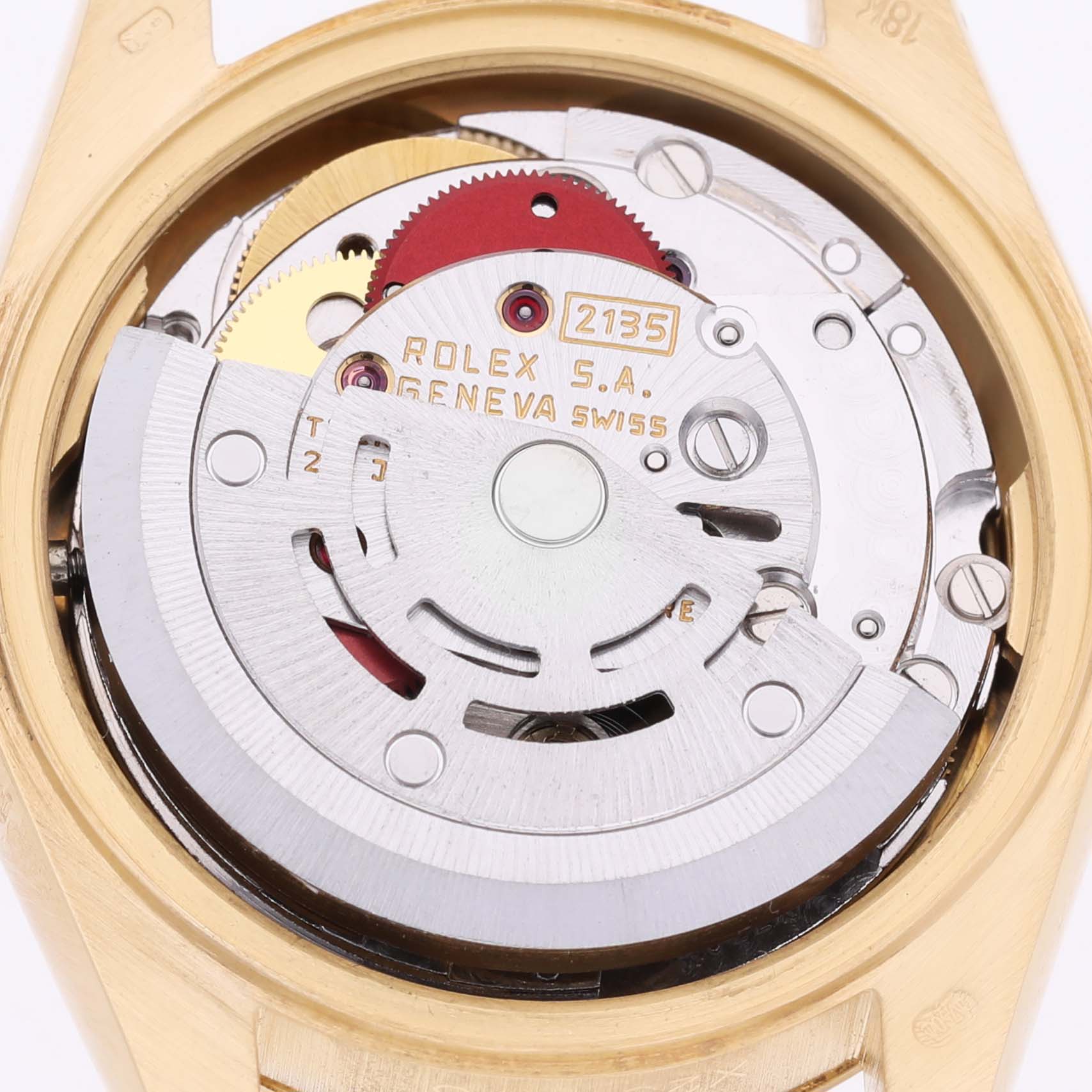 The image shows the movement of a Rolex President 69178 Women's Yellow Gold Champagne Dial model watch viewed from the back, featuring its intricate mechanical components.