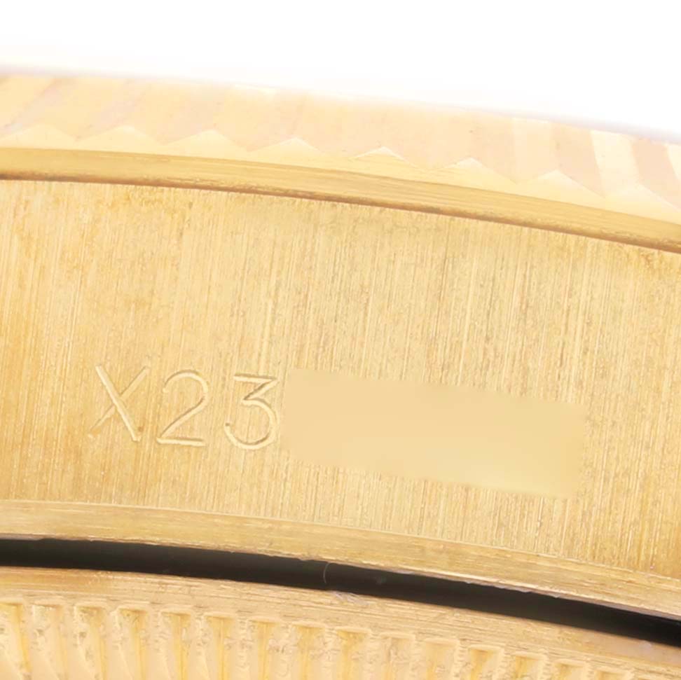 The image shows a close-up of the side engraving on a Rolex President 69178 Women's Yellow Gold Champagne Dial watch, focusing on the serial number.