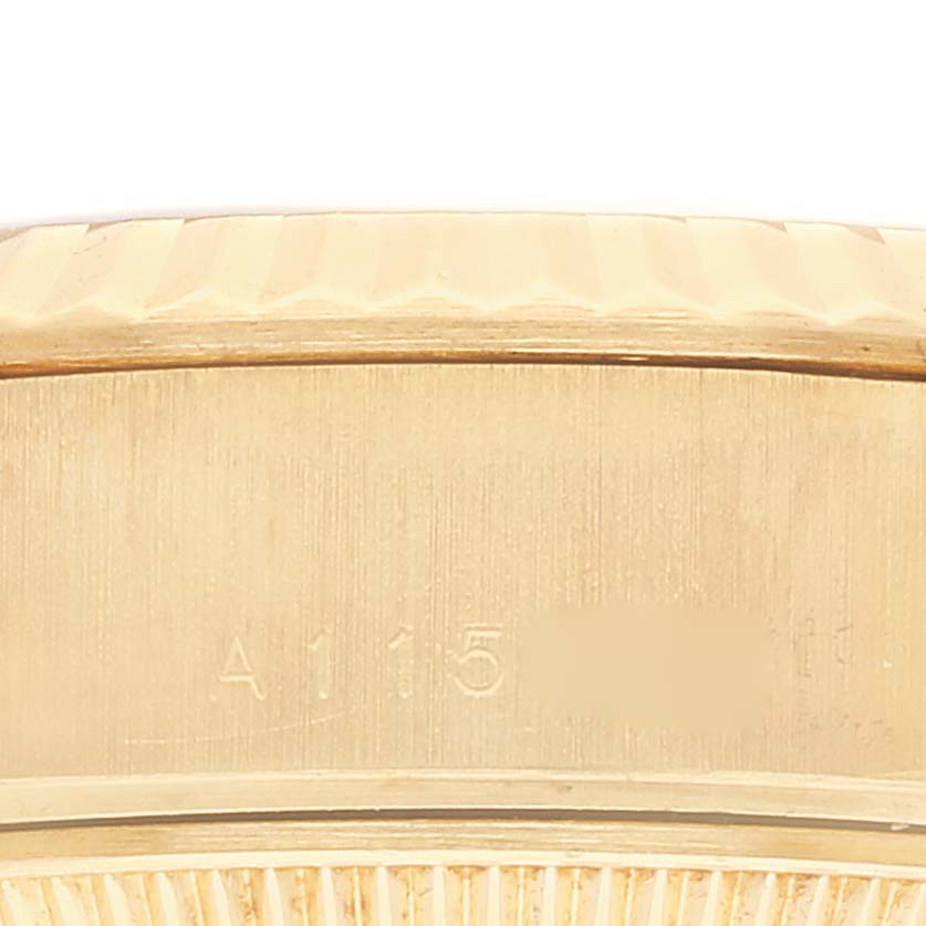 The image shows a close-up of the side of a Rolex President 79178 Women's Yellow Gold Black Dial 79178 Women's Yellow Gold Black Dial model watch, focusing on the engraved serial number.