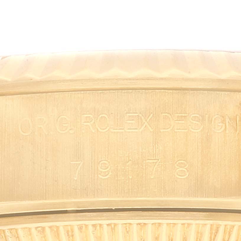 This close-up image shows the engraved model number and "ORIG. ROLEX DESIGN" on the side of a Rolex President 79178 Women's Yellow Gold Black Dial 79178 Women's Yellow Gold Black Dial watch case.