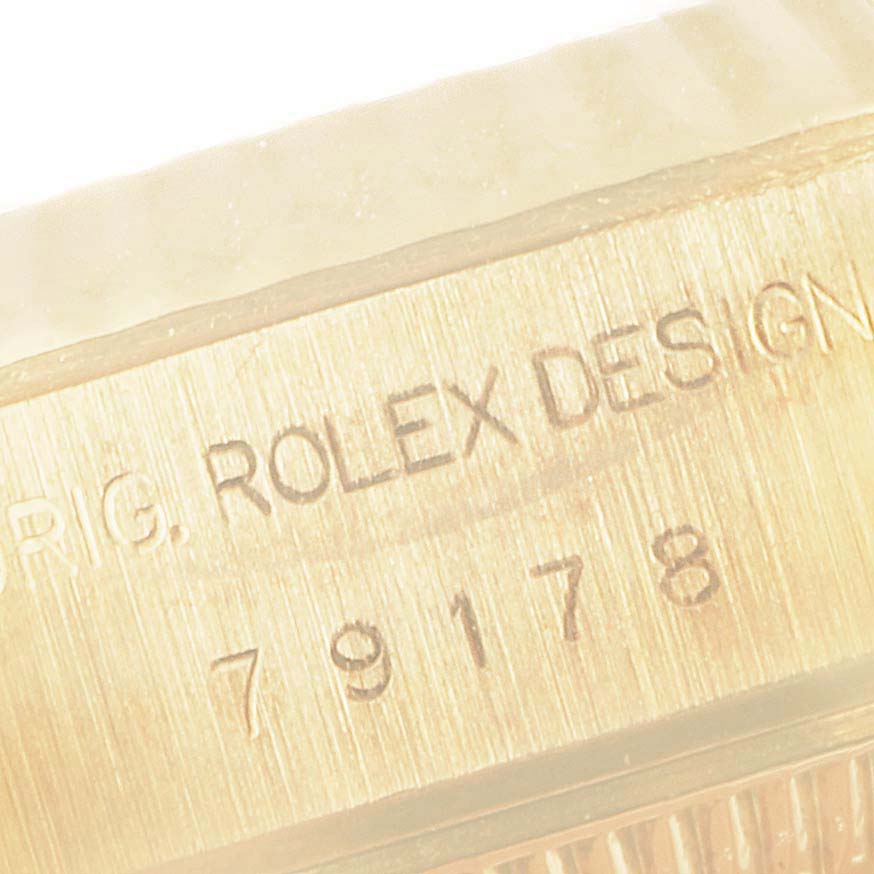 The close-up image shows the engraved side of a Rolex President 79178 Women's Yellow Gold Black Dial 79178 Women's Yellow Gold Black Dial watch, displaying the text "ROLEX DESIGN" and model number "79178".