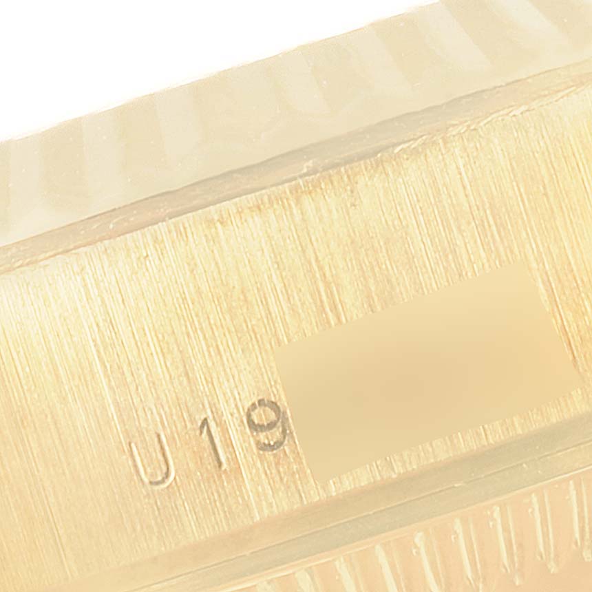 This close-up image shows the side of a Rolex President 79178 Women's Yellow Gold Black Dial 79178 Women's Yellow Gold Black Dial model watch, highlighting the serial number engraving.