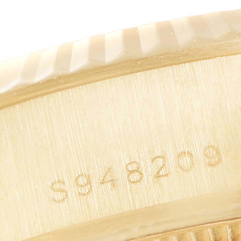 This close-up image shows the side engraving detail of a Rolex President 69178 Women's Yellow Gold Black Dial 69178 Women's Yellow Gold Black Dial model watch.