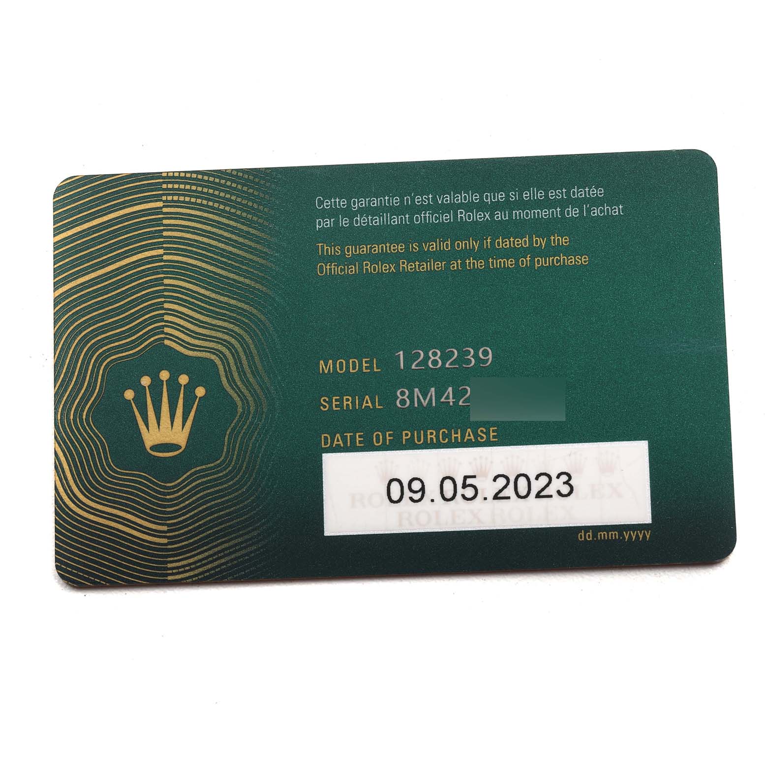 The image shows the warranty card for a Rolex President 128239 Men
s White Gold Blue Dial 128239 Men
s White Gold Blue Dial model, detailing the model and serial number.