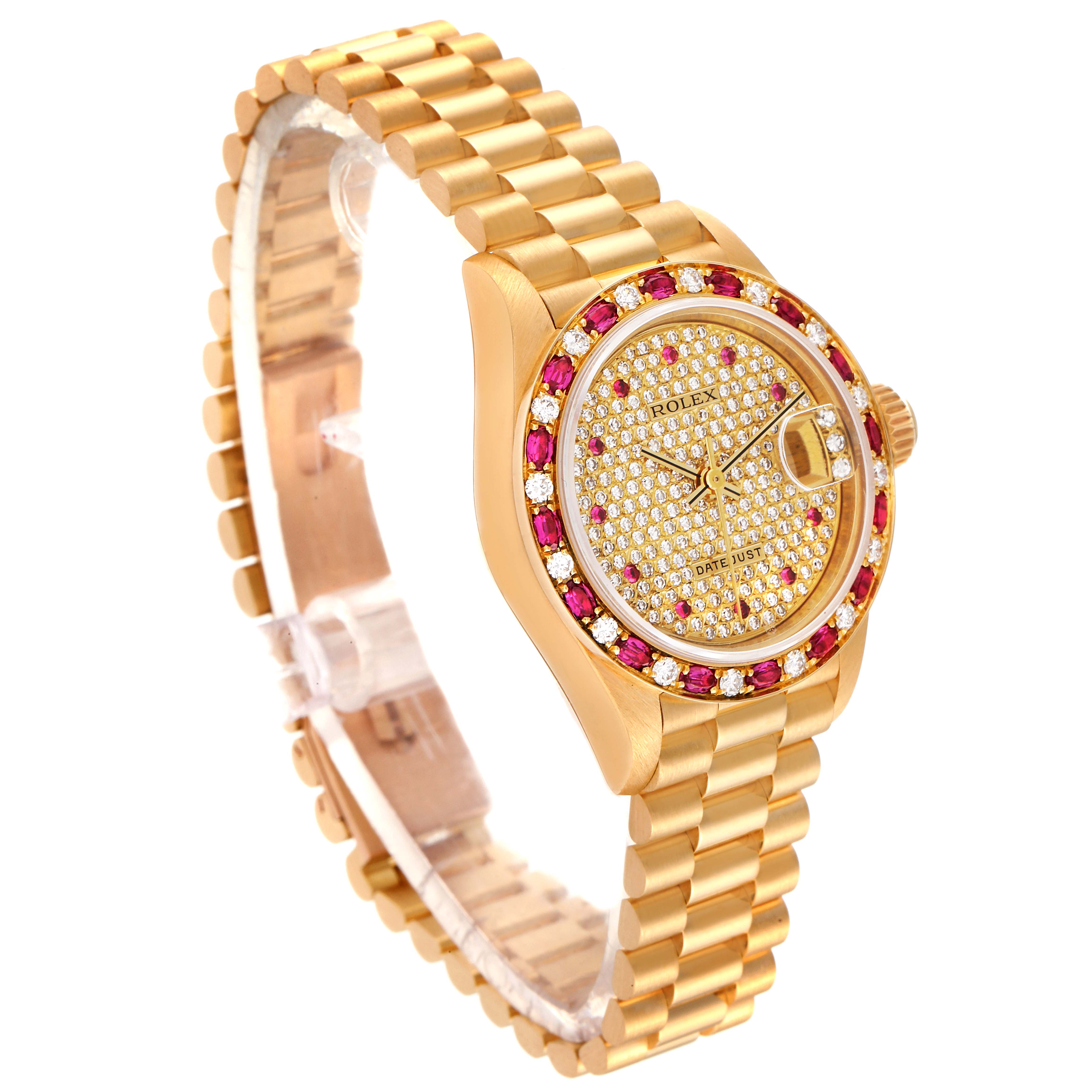 This image shows a Rolex President 69198 Women's Yellow Gold  69198 Women's Yellow Gold  model watch at an angled view, highlighting its gold bracelet, diamond-studded dial, and ruby-accented bezel.