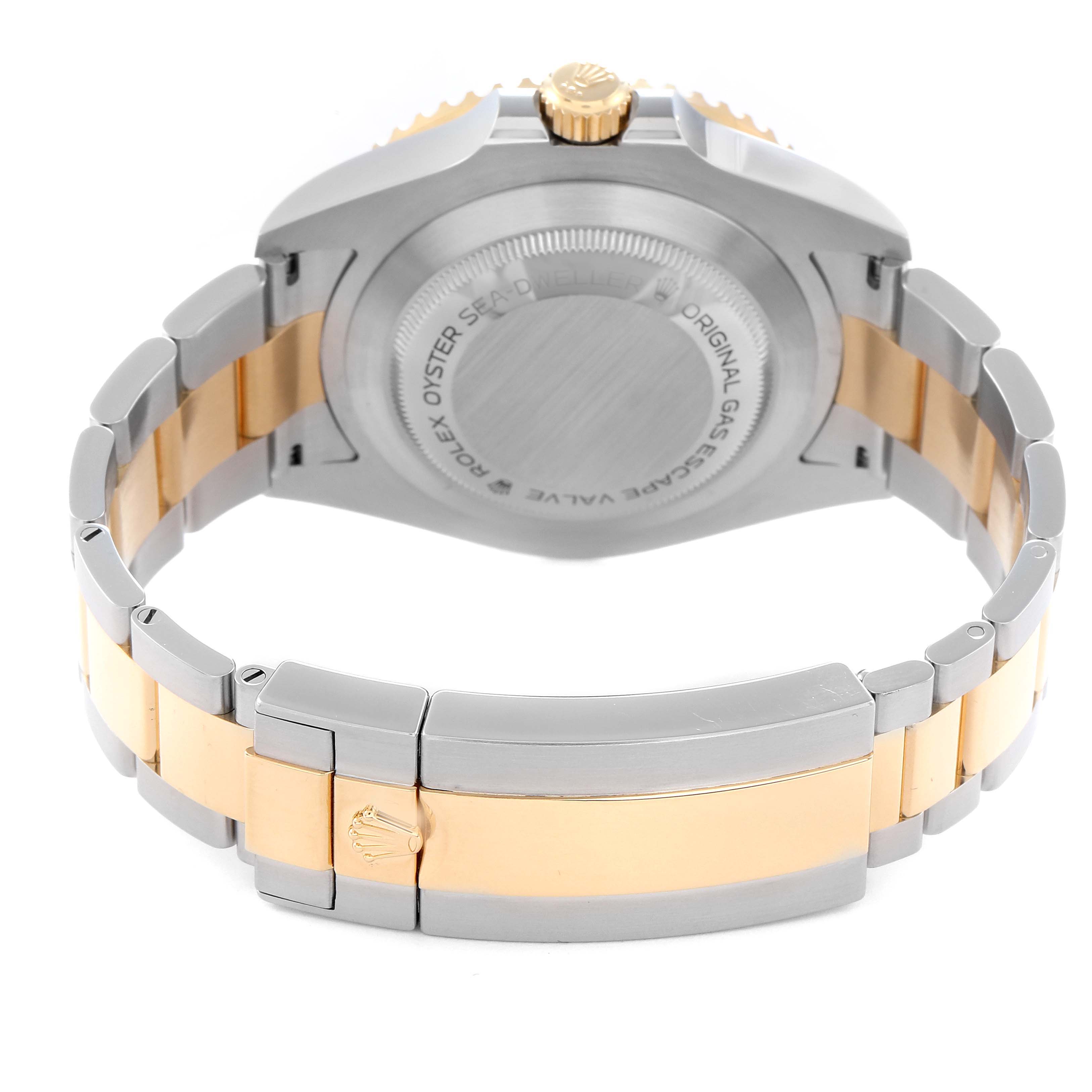 The image shows the back and bracelet of a Rolex Sea-Dweller 126603 Men
s Steel and Gold (two tone) Black Dial 126603 Men
s Steel and Gold (two tone) Black Dial, highlighting the clasp and two-tone metal design.