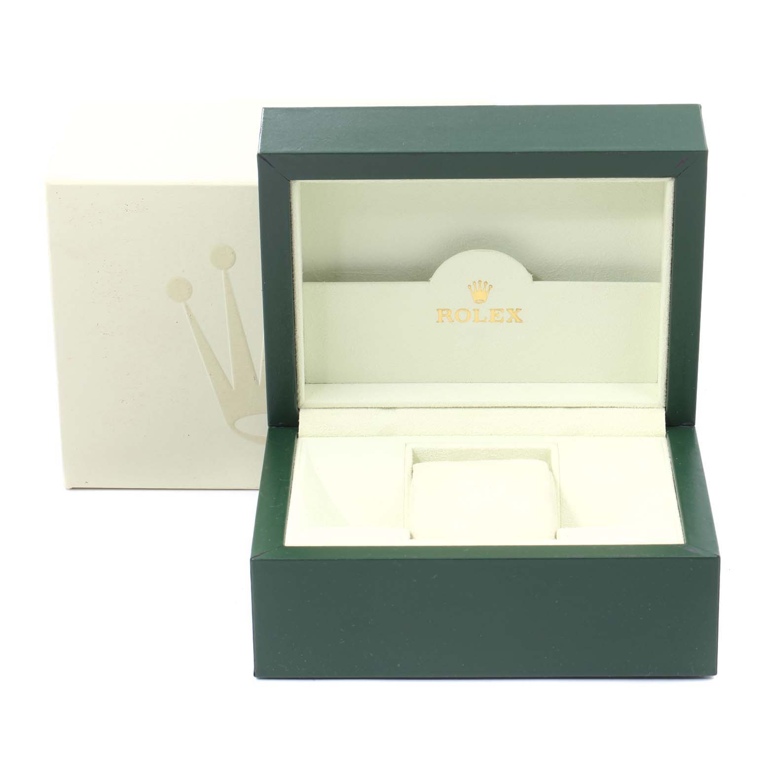 This image shows an open, empty green and cream Rolex watch box for the Submariner model.
