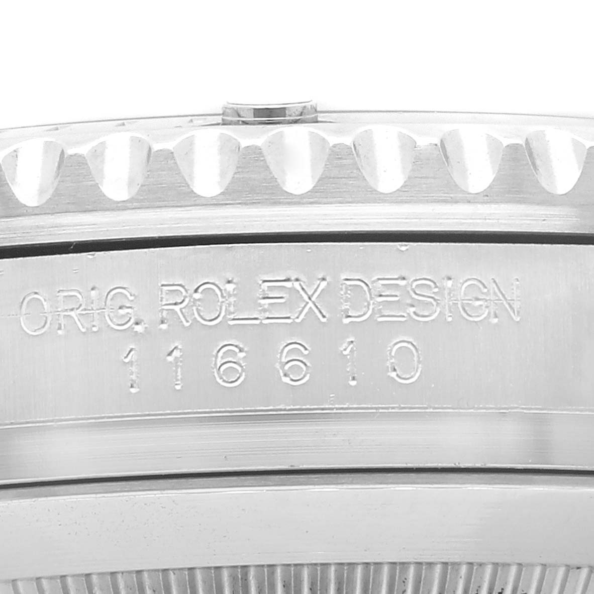 This is a close-up view of the side of a Rolex Submariner 116610LV Men
s Stainless Steel Green Dial 116610LV Men
s Stainless Steel Green Dial, showing the inscription "ORIG. ROLEX DESIGN 116610" and part of the bezel.
