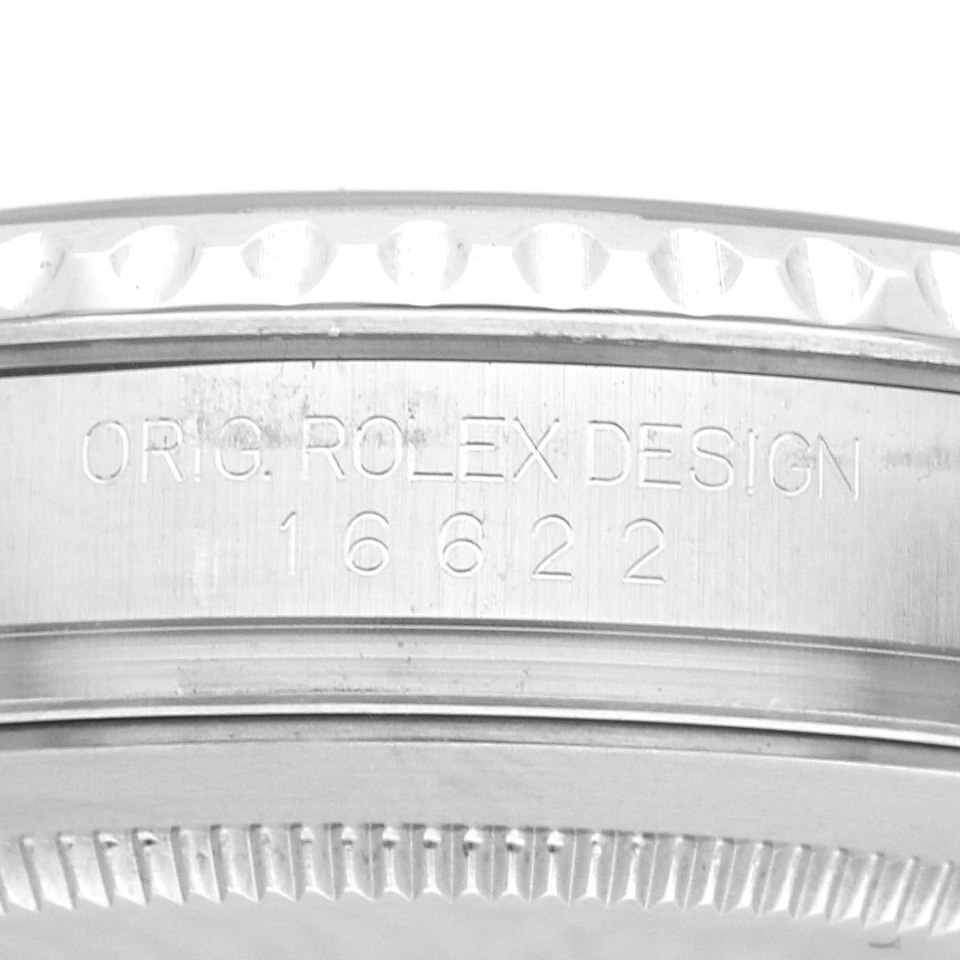 The image shows a close-up of the side of a Rolex Yacht-Master 16622 Men
s Stainless Steel Silver Dial 16622 Men
s Stainless Steel Silver Dial watch, featuring engraving and part of the bezel.