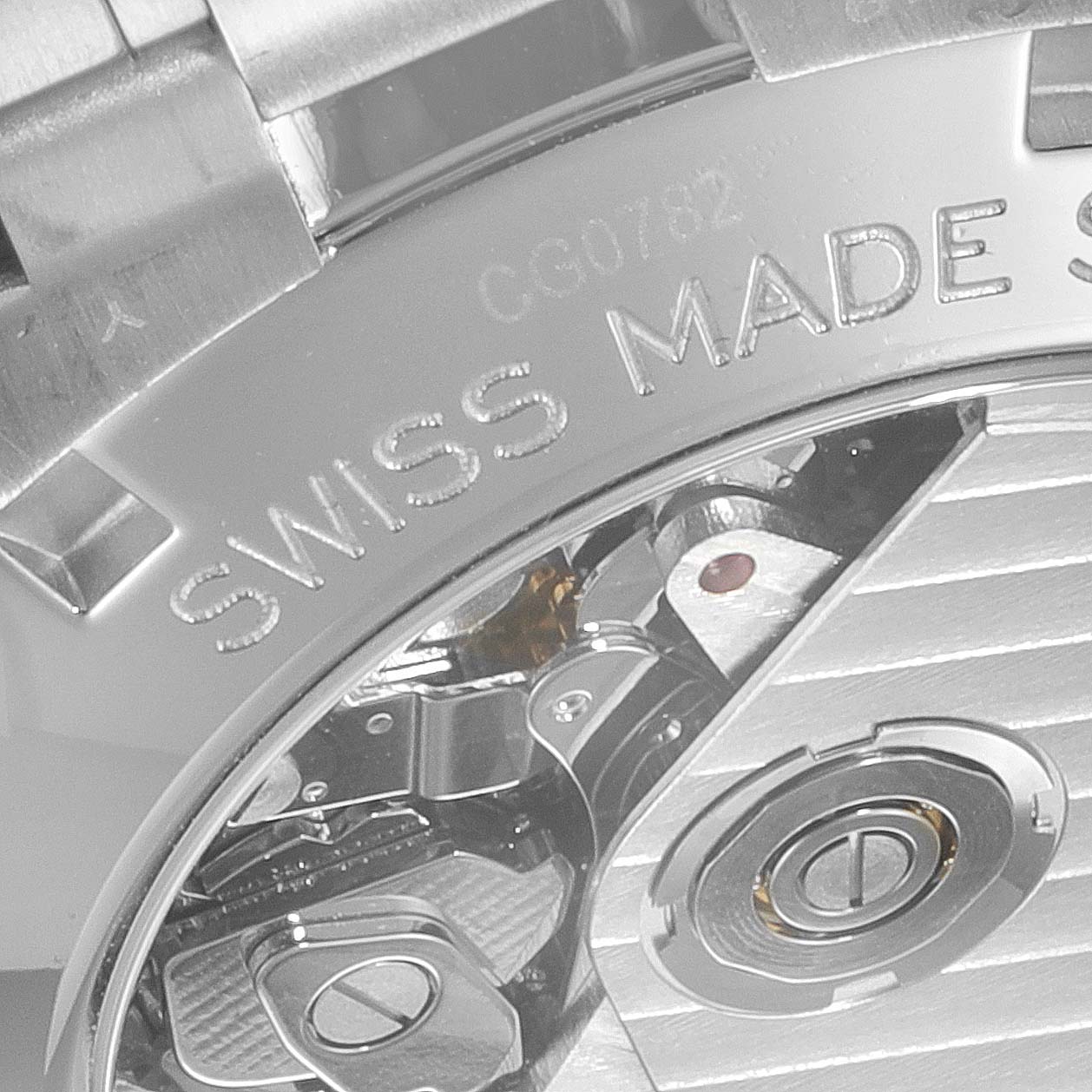This close-up image shows the back of a Tag Heuer Carrera CV2050.BD0789 Men's Steel and Gold (two tone) Silver Dial CV2050.BD0789 Men's Steel and Gold (two tone) Silver Dial watch, highlighting the "Swiss Made" engraving and internal mechanical components.