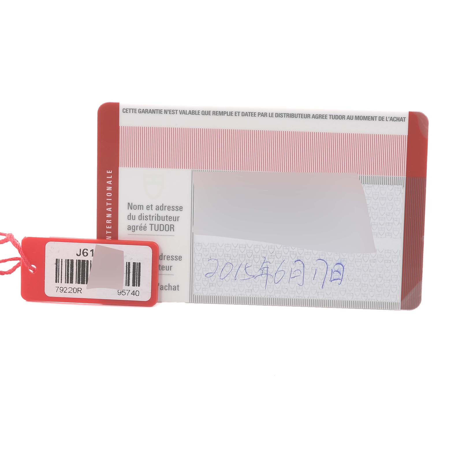 The image shows a warranty card and tag for the Tudor Heritage Black Bay 79220R Men
s Stainless Steel Black Dial 79220R Men
s Stainless Steel Black Dial watch.