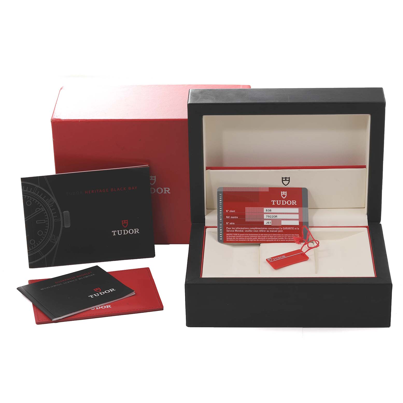 The image shows the box, warranty card, and manuals for the Tudor Heritage Black Bay 79220R Men
s Stainless Steel Black Dial 79220R Men
s Stainless Steel Black Dial watch.