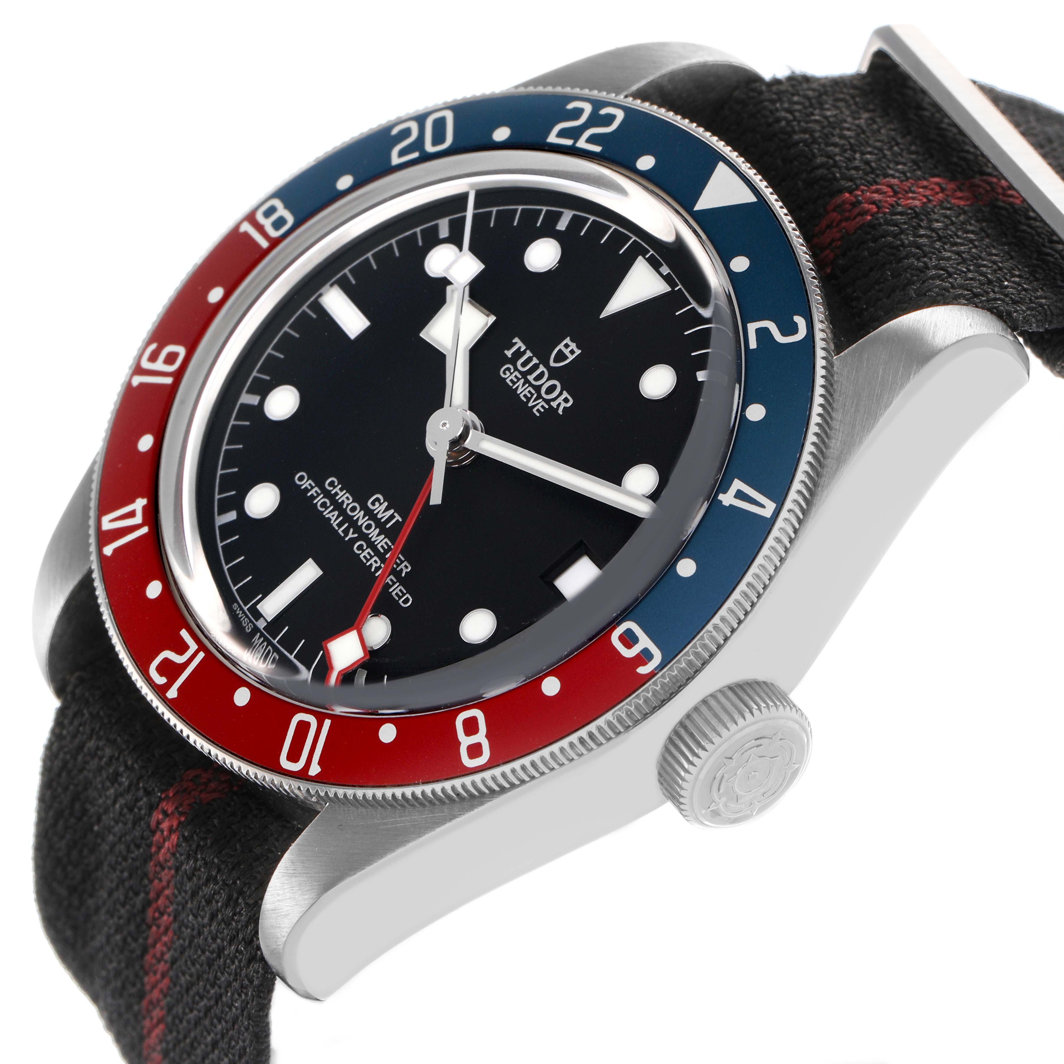 The Tudor Heritage Black Bay 79830RB Men's Stainless Steel Black Dial watch is shown at an angle highlighting the bezel, dial, crown, and fabric strap.