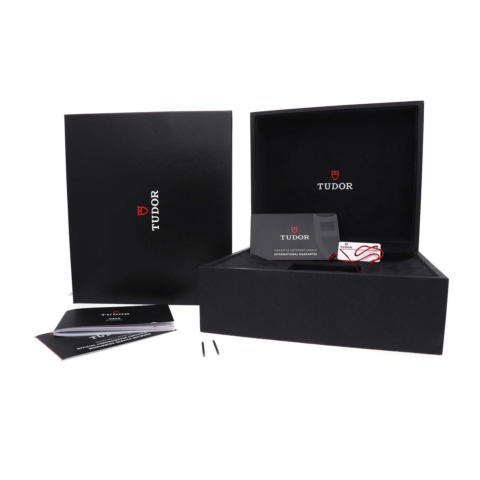 The image shows the Tudor Heritage Black Bay 79830RB Men's Stainless Steel Black Dial packaging, warranty card, booklets, and a box, all viewed from a front angle.
