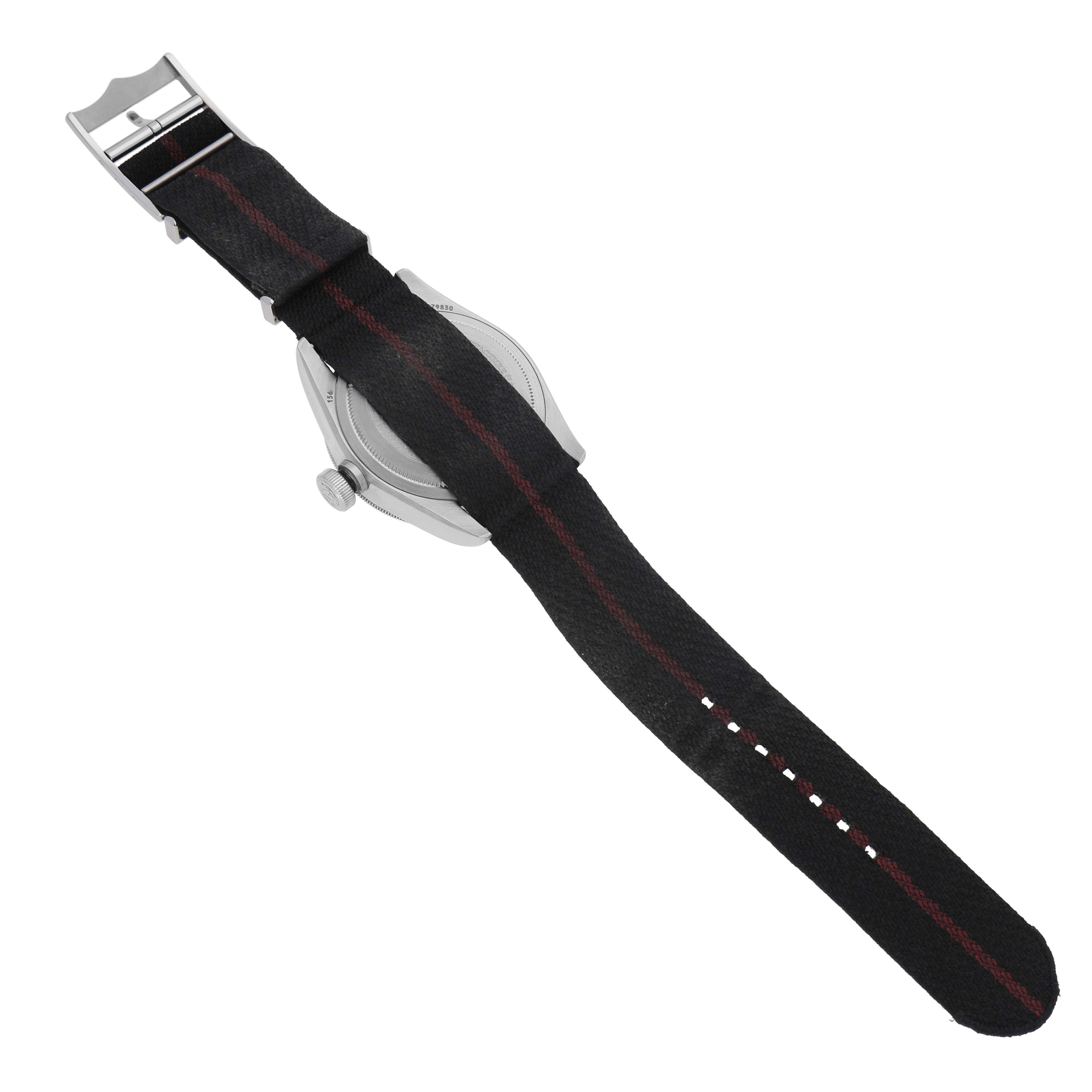 The Tudor Heritage Black Bay 79830RB Men's Stainless Steel Black Dial watch is shown from the back, highlighting the strap and buckle.
