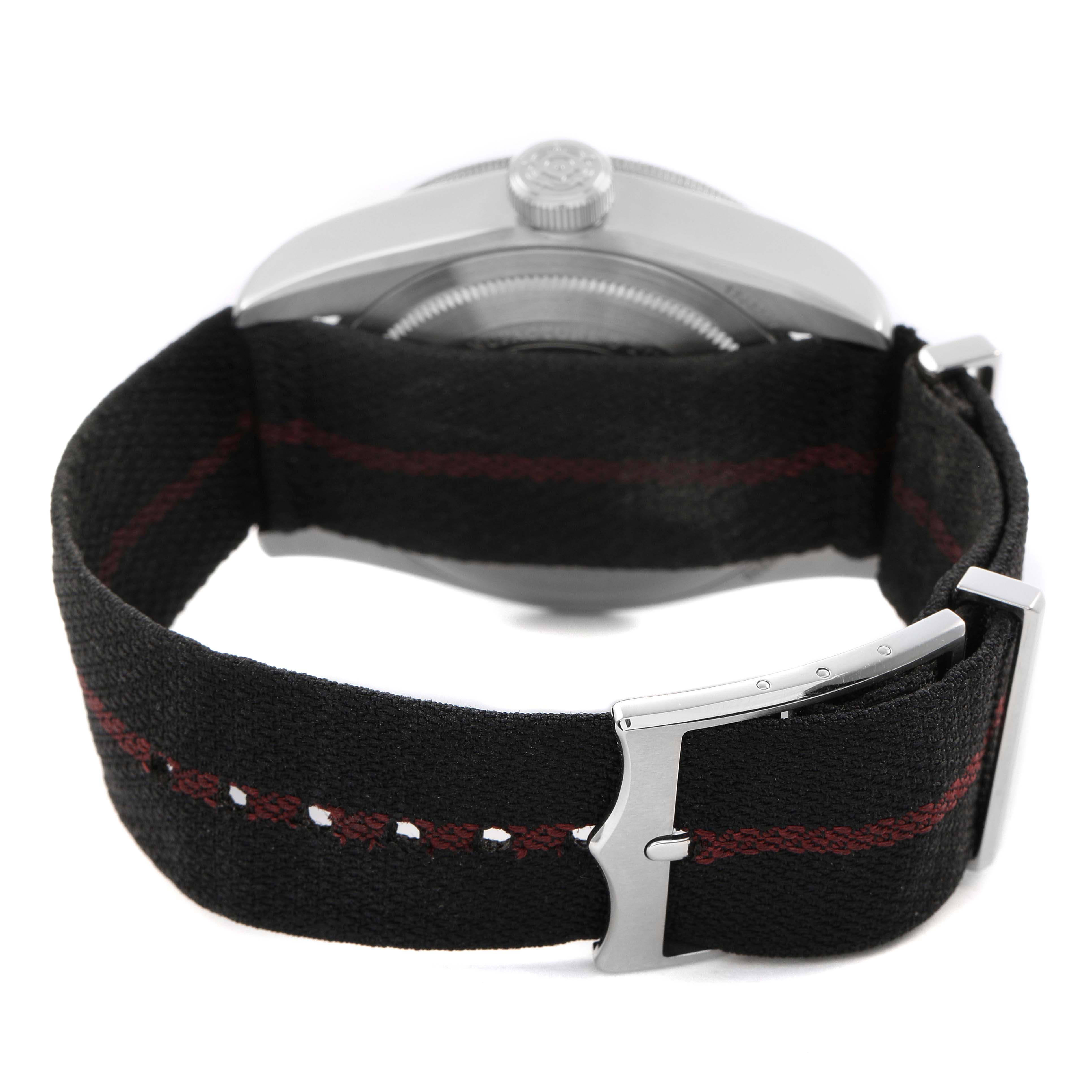 The image shows the side view of a Tudor Heritage Black Bay 79830RB Men's Stainless Steel Black Dial watch focusing on the fabric strap and clasp.