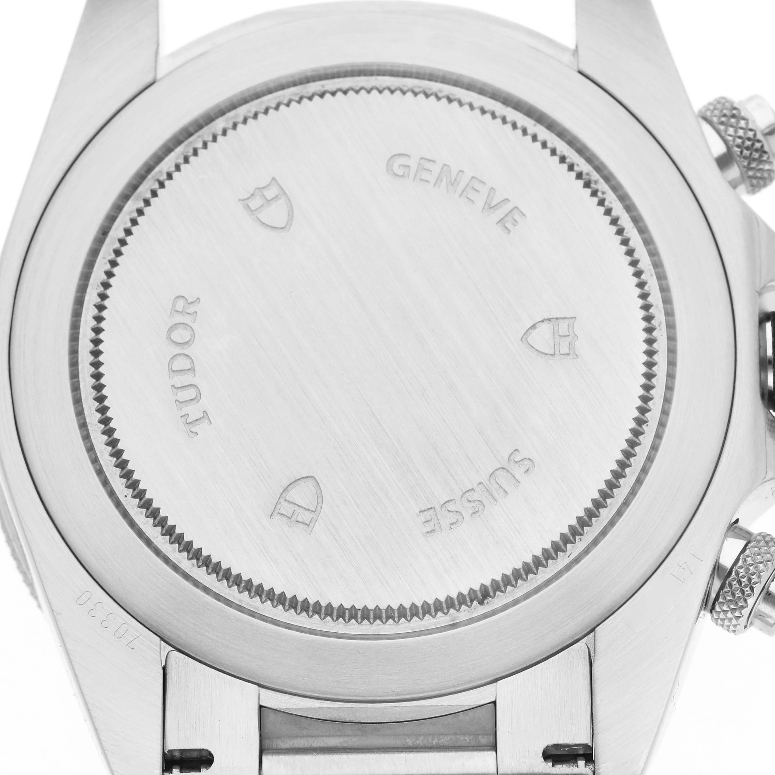 The image shows the back case of a Tudor Heritage Chrono 70330 Men's Stainless Steel Black Dial 70330 Men's Stainless Steel Black Dial watch, featuring engravings and a brushed metal finish.