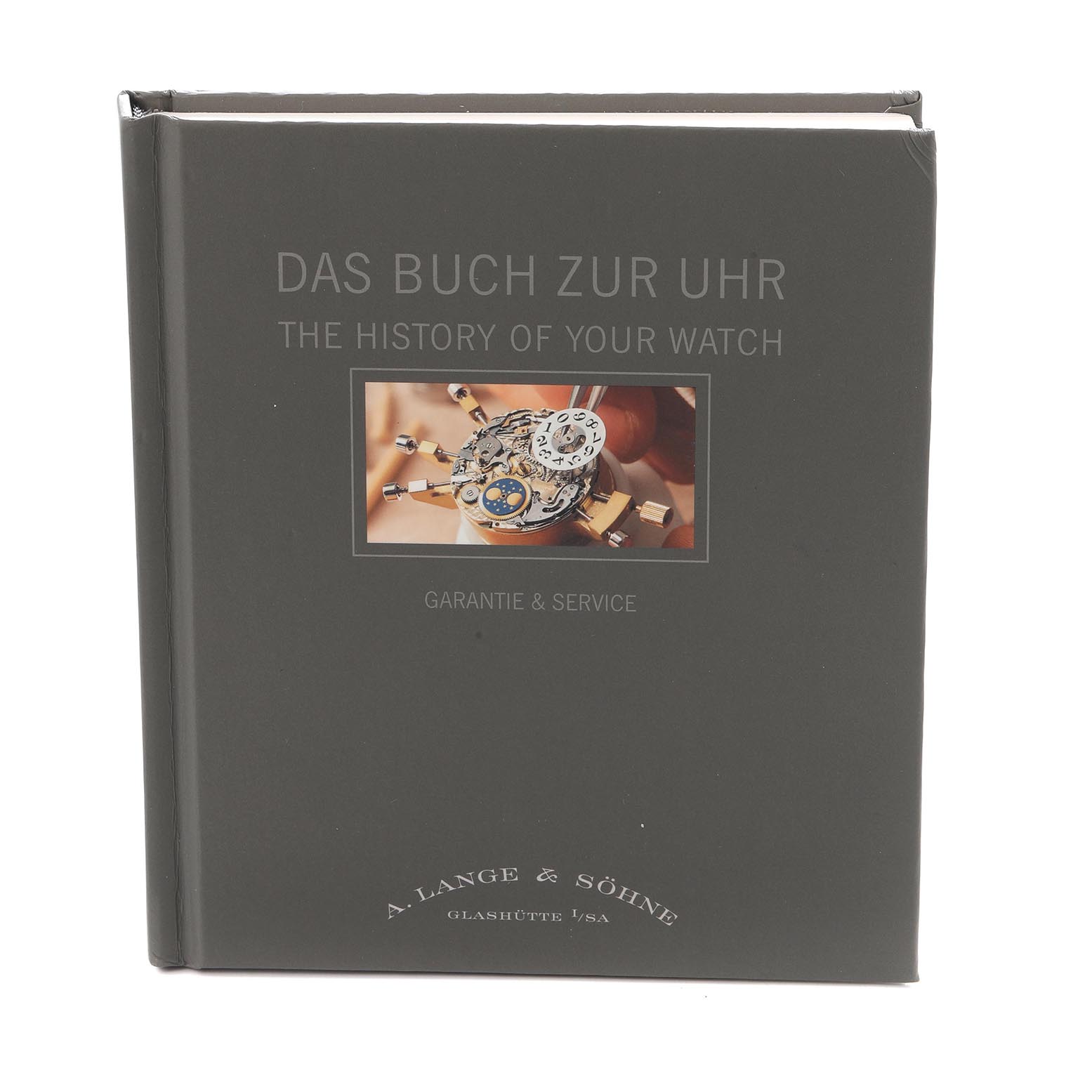 The image shows a book titled "The History of Your Watch" featuring a close-up of a Lange 1 model movement by A. Lange & Söhne.