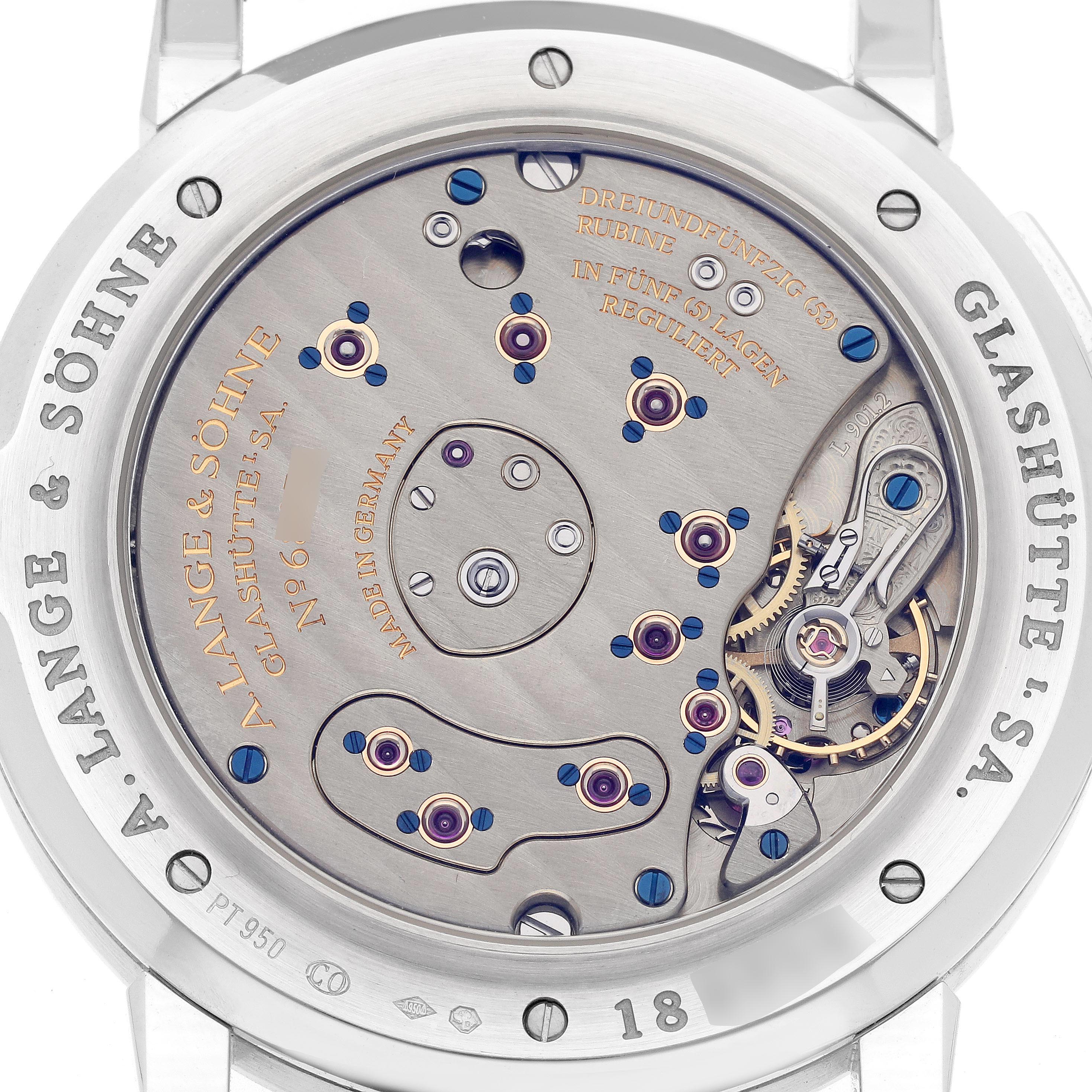 The image shows the back view of the A. Lange & Sohne Lange 1 115.026 Men's Platinum Silver Dial watch, highlighting the intricate movement and engravings.