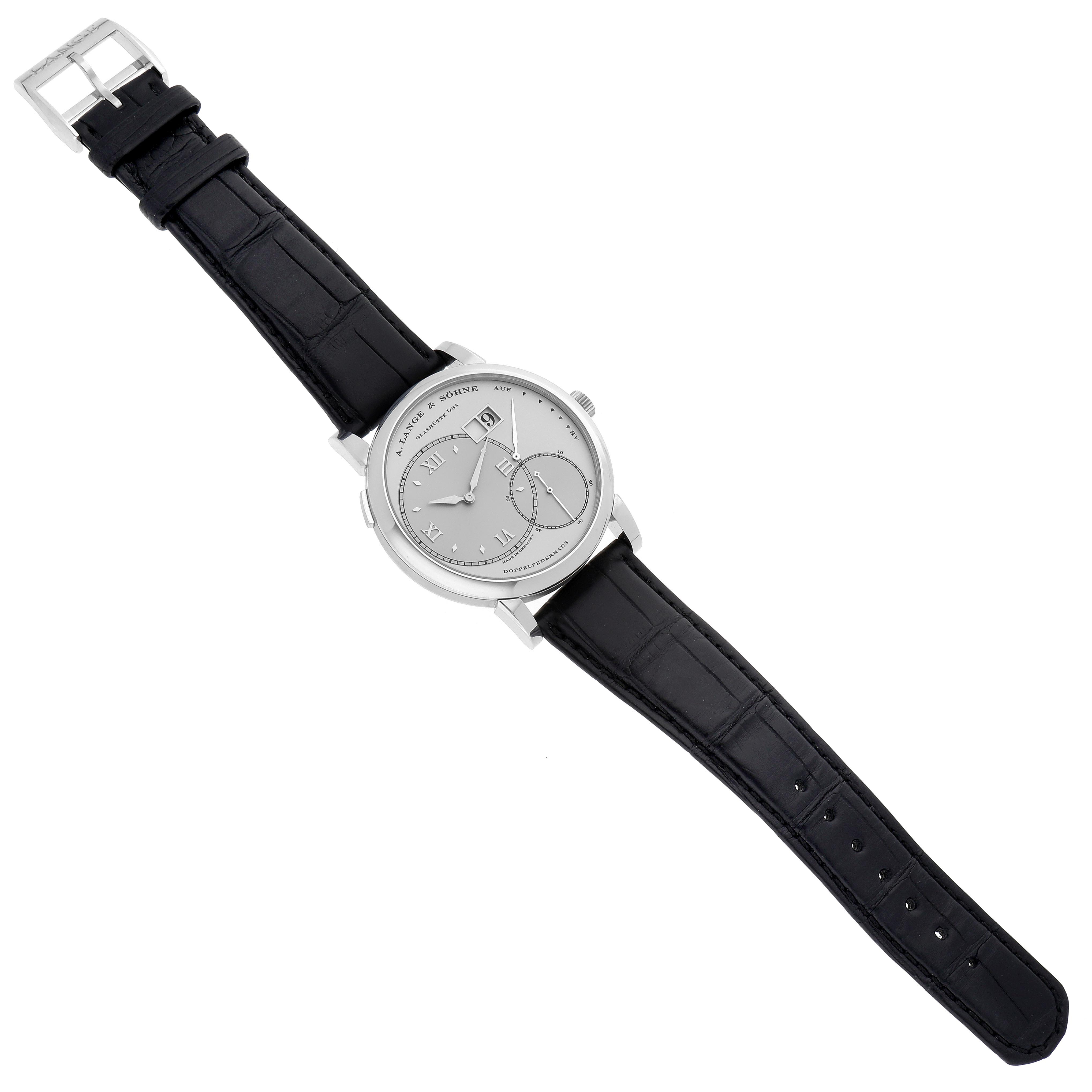 The Lange 1 by A. Lange & Söhne is shown from a top-down angle, highlighting the dial, case, and black leather strap.