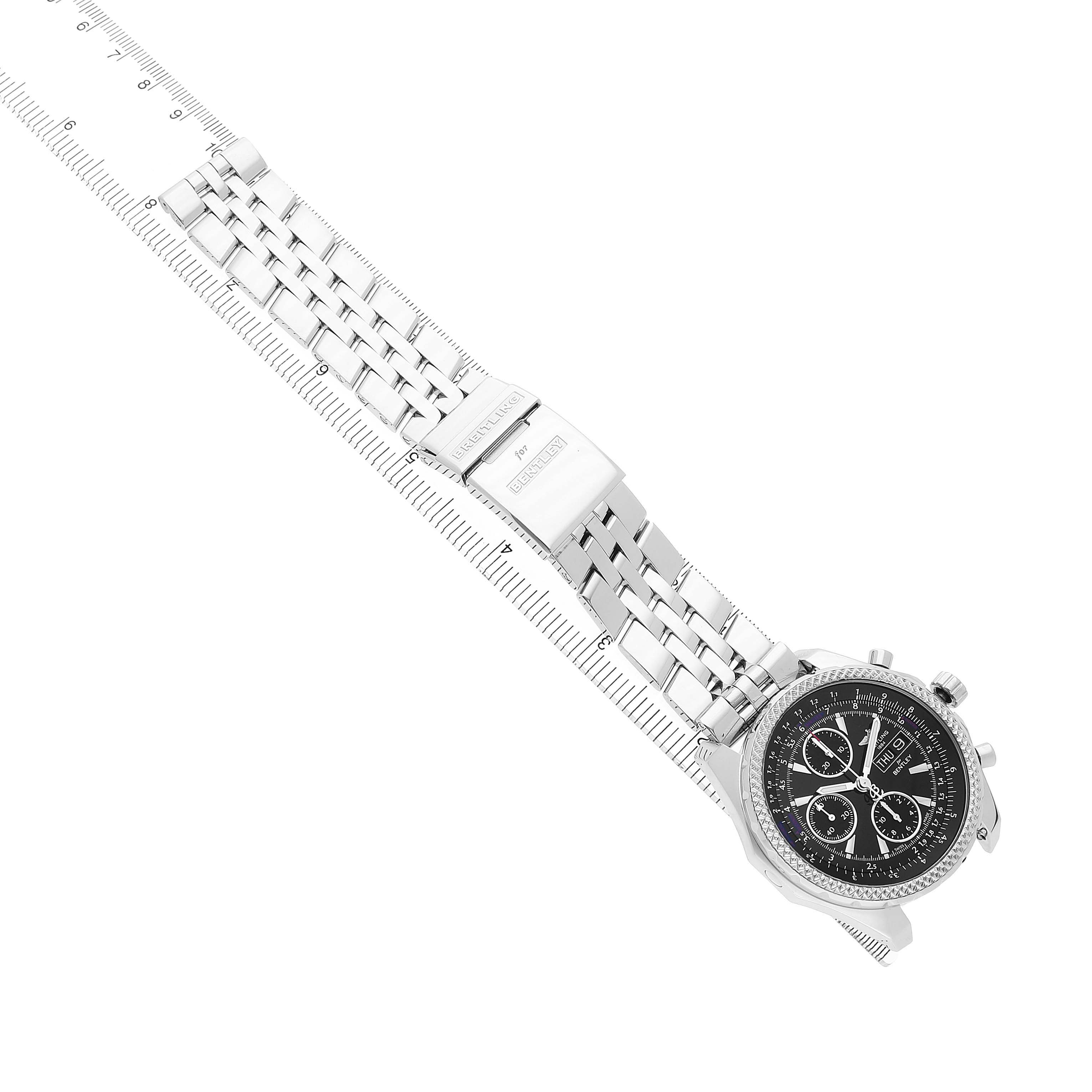 The Breitling Bentley A13362 Men's Stainless Steel Black Dial watch is shown at an angle displaying its face, bracelet, and clasp on a ruler background.