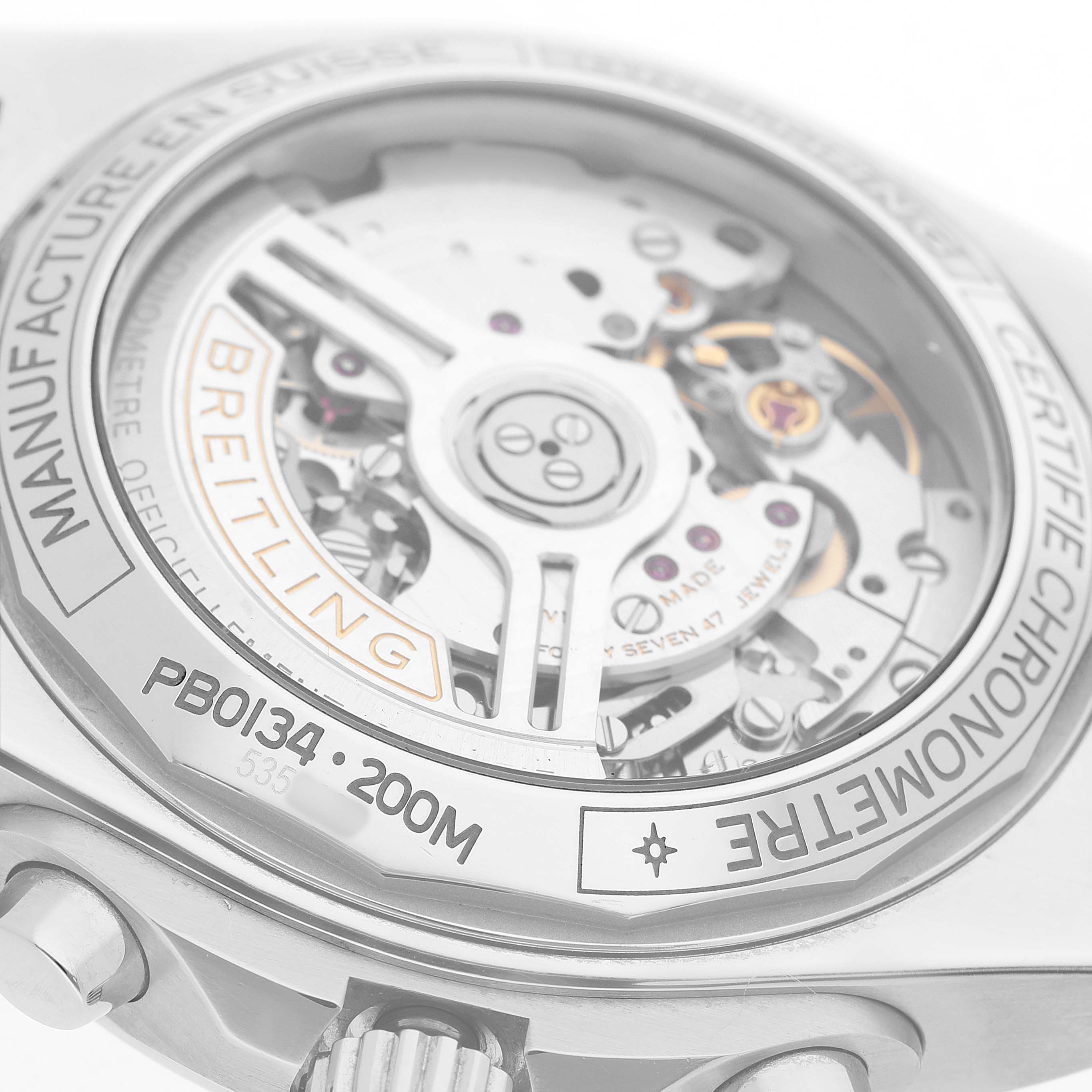 The image shows the back of the Breitling Chronomat PB0134 Men's Stainless Steel Blue Dial watch, highlighting its intricate movement and branding details.