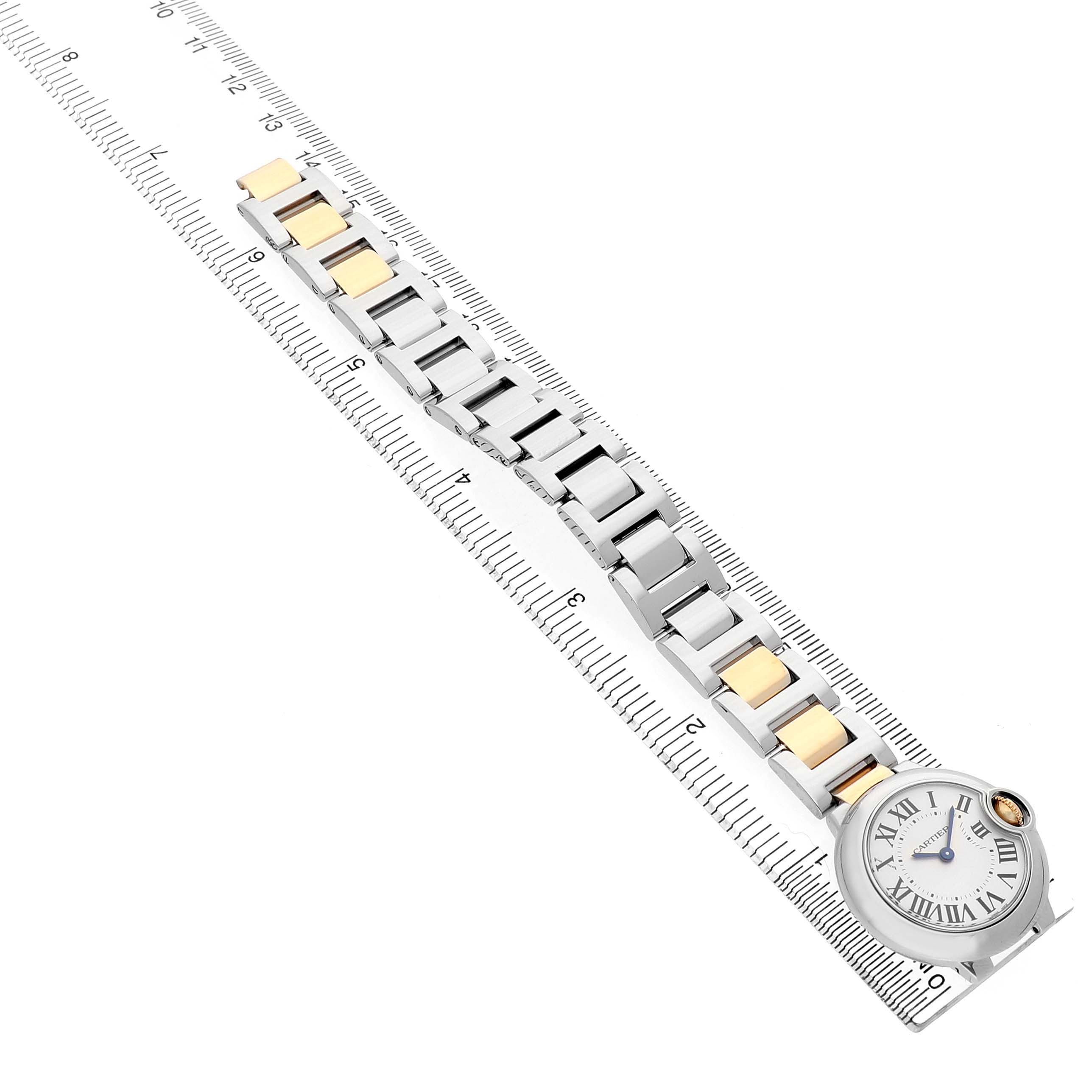 The Cartier Ballon Bleu W69007Z3 Women's Steel and Gold (two tone) Silver Dial watch is pictured from a top-down angle, showing the face, bracelet, and adjacent ruler for measurement.